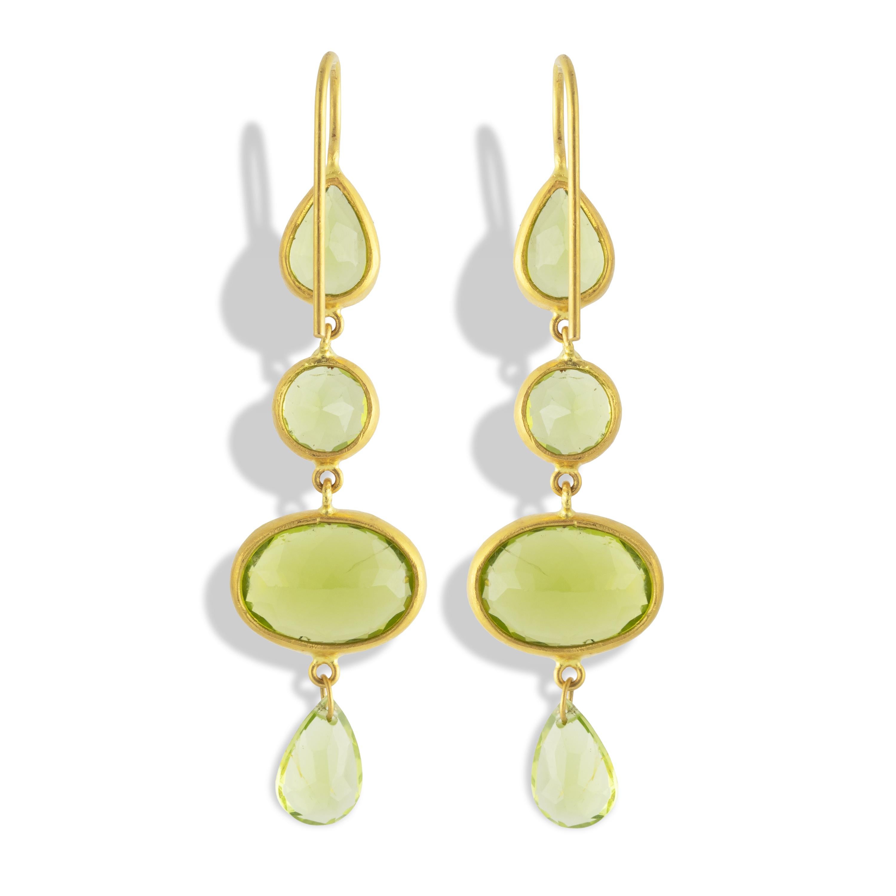 These earrings feature 22.6 carats of stunning Peridot in mixed shapes (ovals, pears, and rounds) sparkle in 22k matte yellow gold.  Measuring 51.5mm (2.02