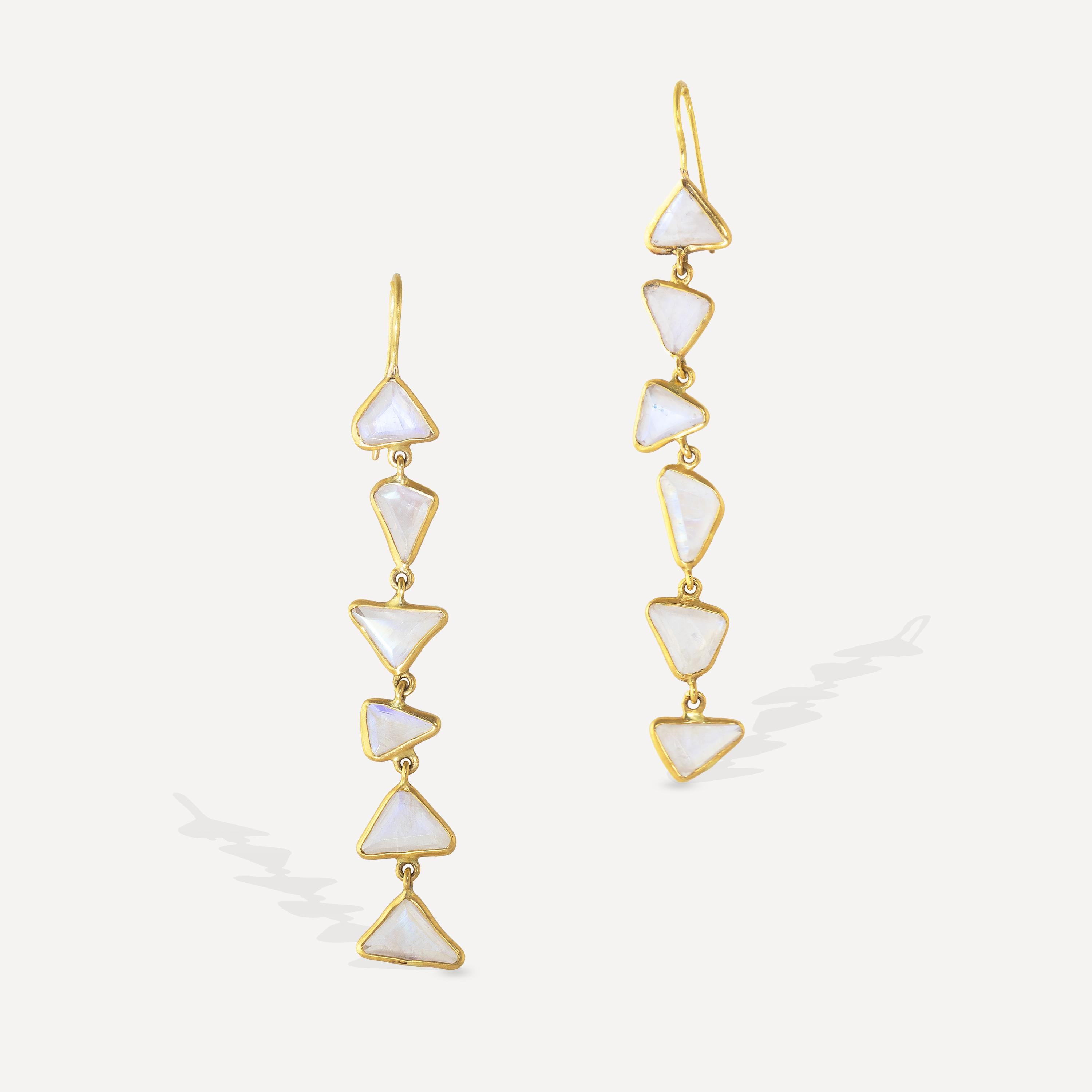 Rainbow Moonstone carved triangles are at the heart of these asymmetrical, one-of-a-kind earrings. Each triangle was carved by had with bezels. The design is based on the beauty of asymmetrical pieces which are all based on the individual