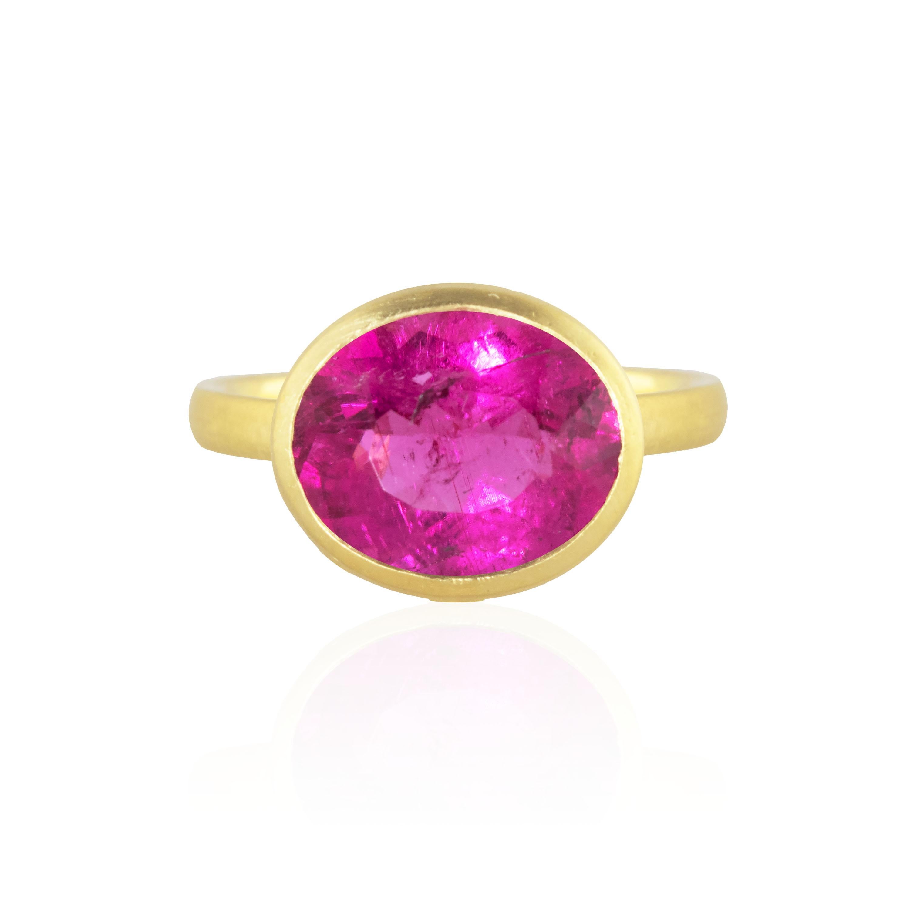 One of a kind wave ring featuring a 3.84 carat Rubellite Tourmaline in the center with a diamond bezel surrounding it.  Eight diamonds weighing .21carats decorate the waves along the gold bezel holding the stone.  Designed with an open back, based