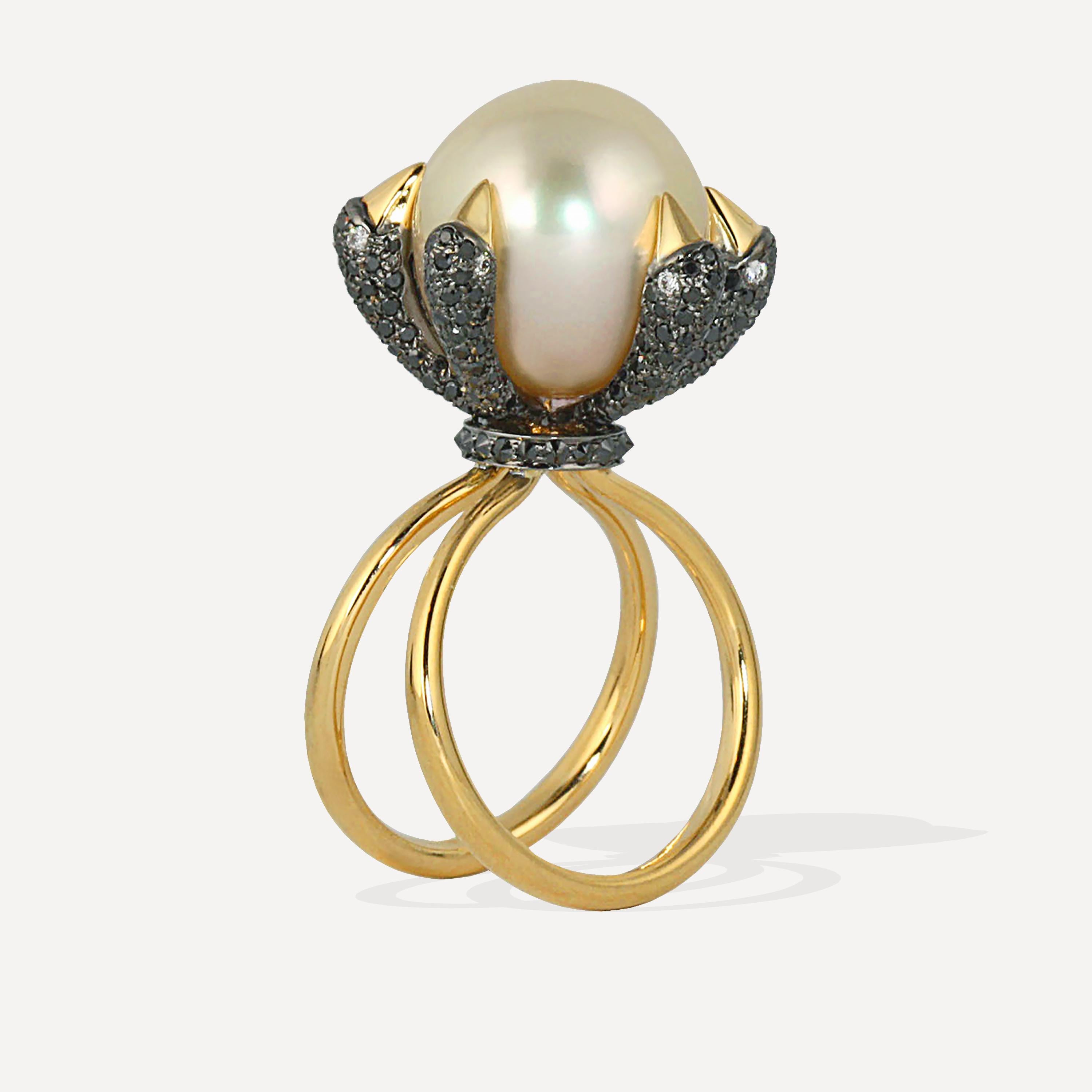 Stunning and dramatic, a 14mm South Sea Pearl is surrounded with five bird heads.  Their yellow gold beaks have 1.33 carats of Black Diamonds and .32 carats of White Diamond eyes and weighing 11 grams.  Inverse black diamonds are set in a collar