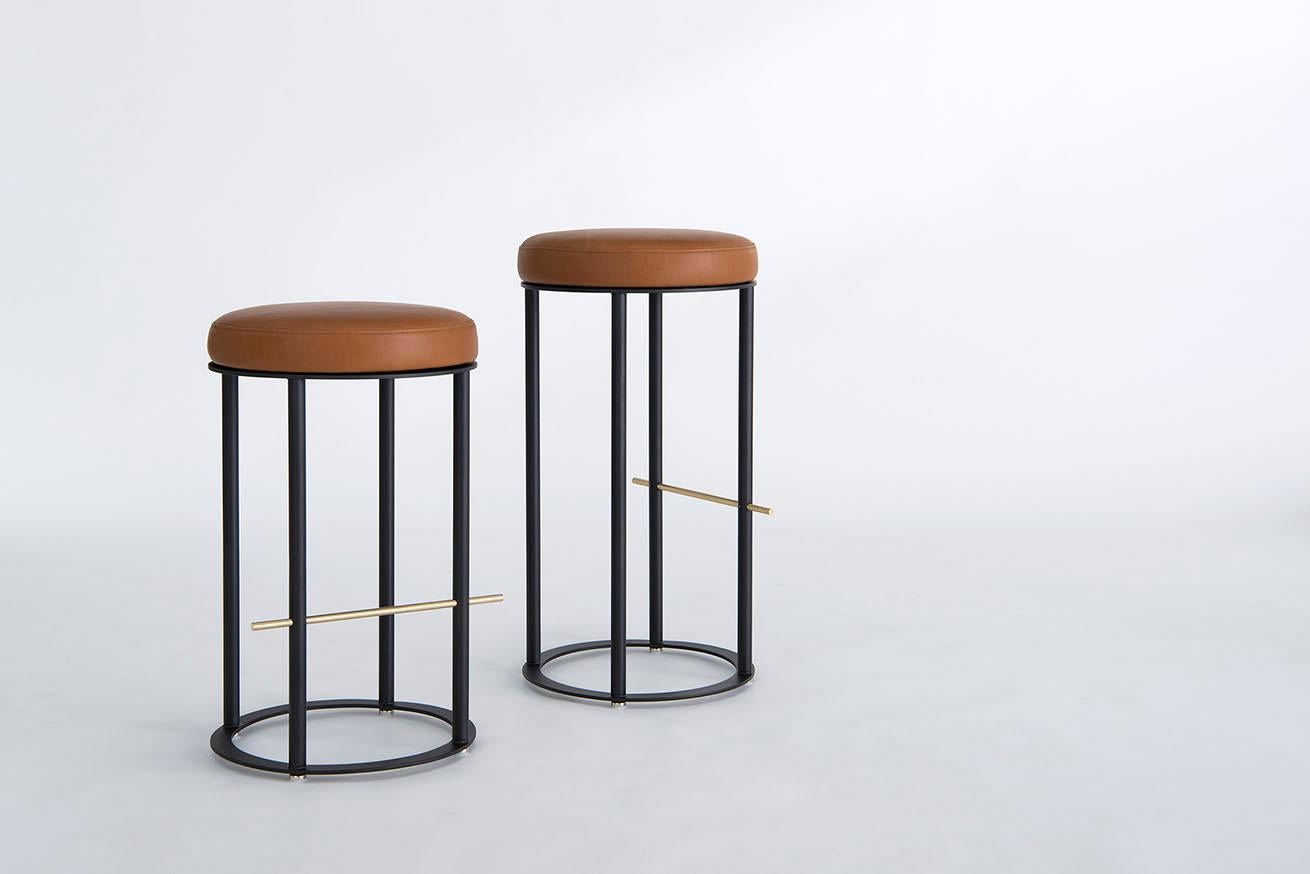 Listed price is for the icon counter stool in powder coat (flat black or flat white) with a solid brushed brass footrest and harness by Moore & Giles leather. 
COL is also available, with a List price of $ 1,875.00.
The Icon Counter Stool is also