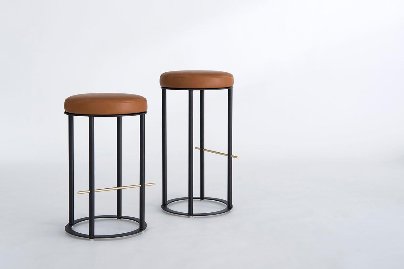 Listed price is for the icon counter stool in powder coat (flat black or flat white) with a solid brushed brass footrest and harness by Moore & Giles leather. 
COL is also available, with a List price of $ 1,805.00.
The icon counter stool is also