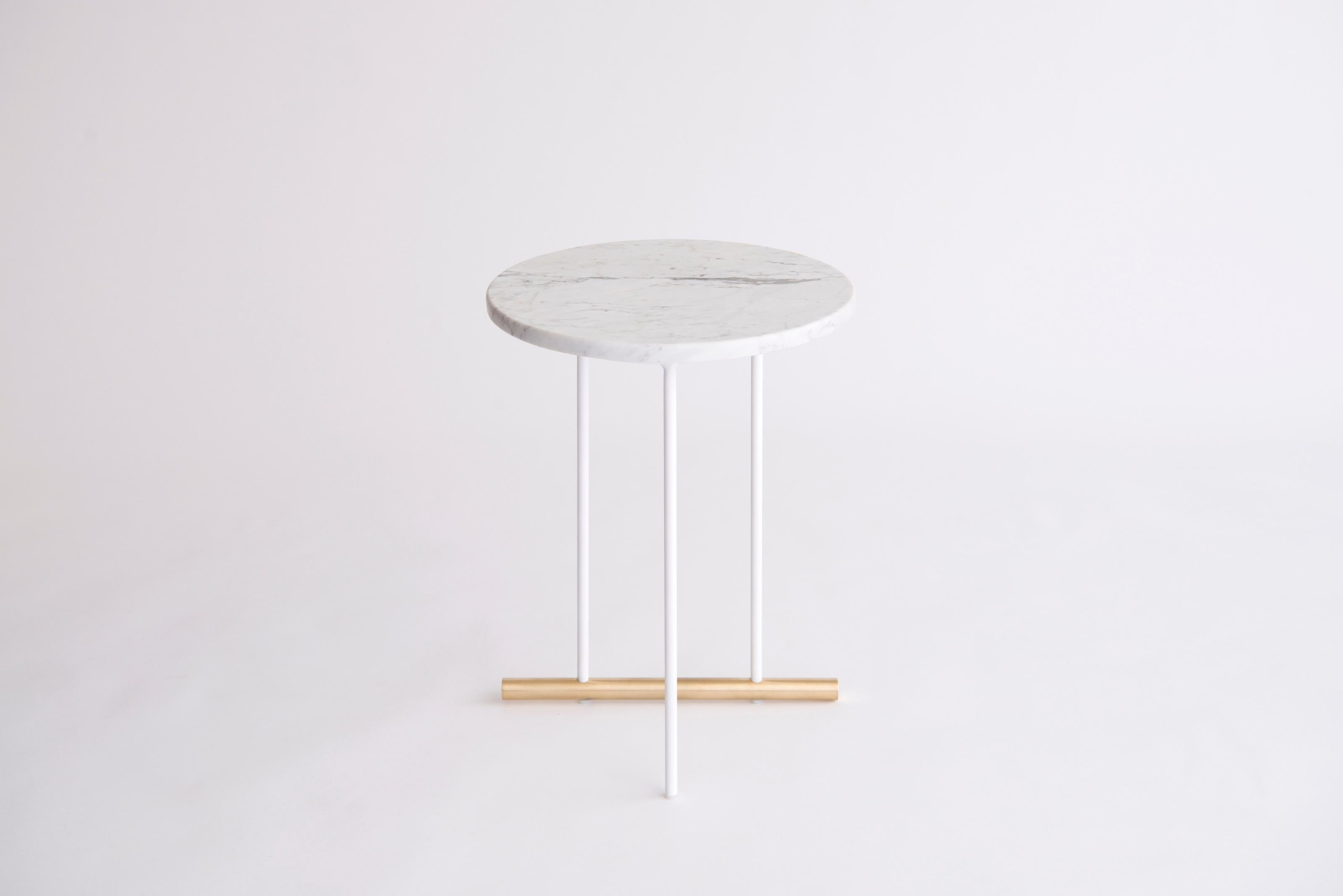 Icon Small White Carrara Side Table by Phase Design
Dimensions: Ø 38,1 H 51.5 cm. 
Materials: White Carrara marble, powder-coated metal and brushed brass.

Solid steel and brass with glass, marble, or solid wooden tops. Steel bar available in a flat