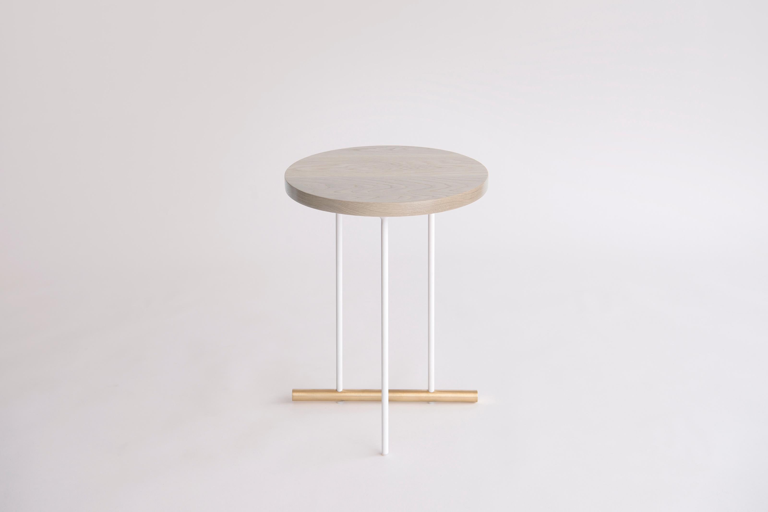 Icon Small White Oak Side Table by Phase Design
Dimensions: Ø 38,1 x H 51.5 cm. 
Materials: White oak, powder-coated metal and brushed brass.

Solid steel and brass with glass, marble, or solid wooden tops. Steel bar available in a flat black or