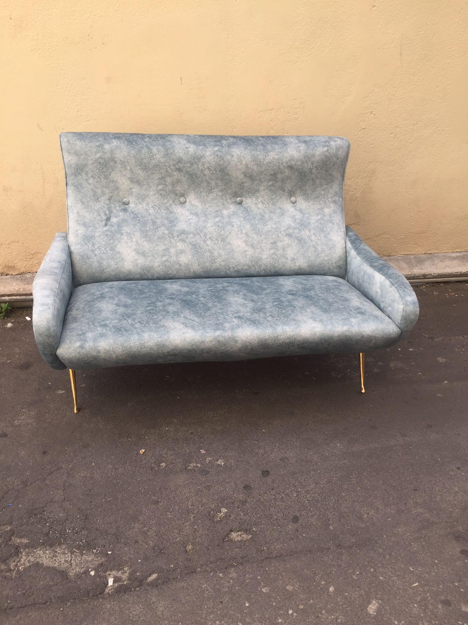 Iconic Mid-Century Modern, Italian modern sofa in velvet in shades of light blue, in the manner of Gigi Radice. The spiked brass feet are original with a beautiful patina, the sofa has been upholstered by a professional in the sector and has never