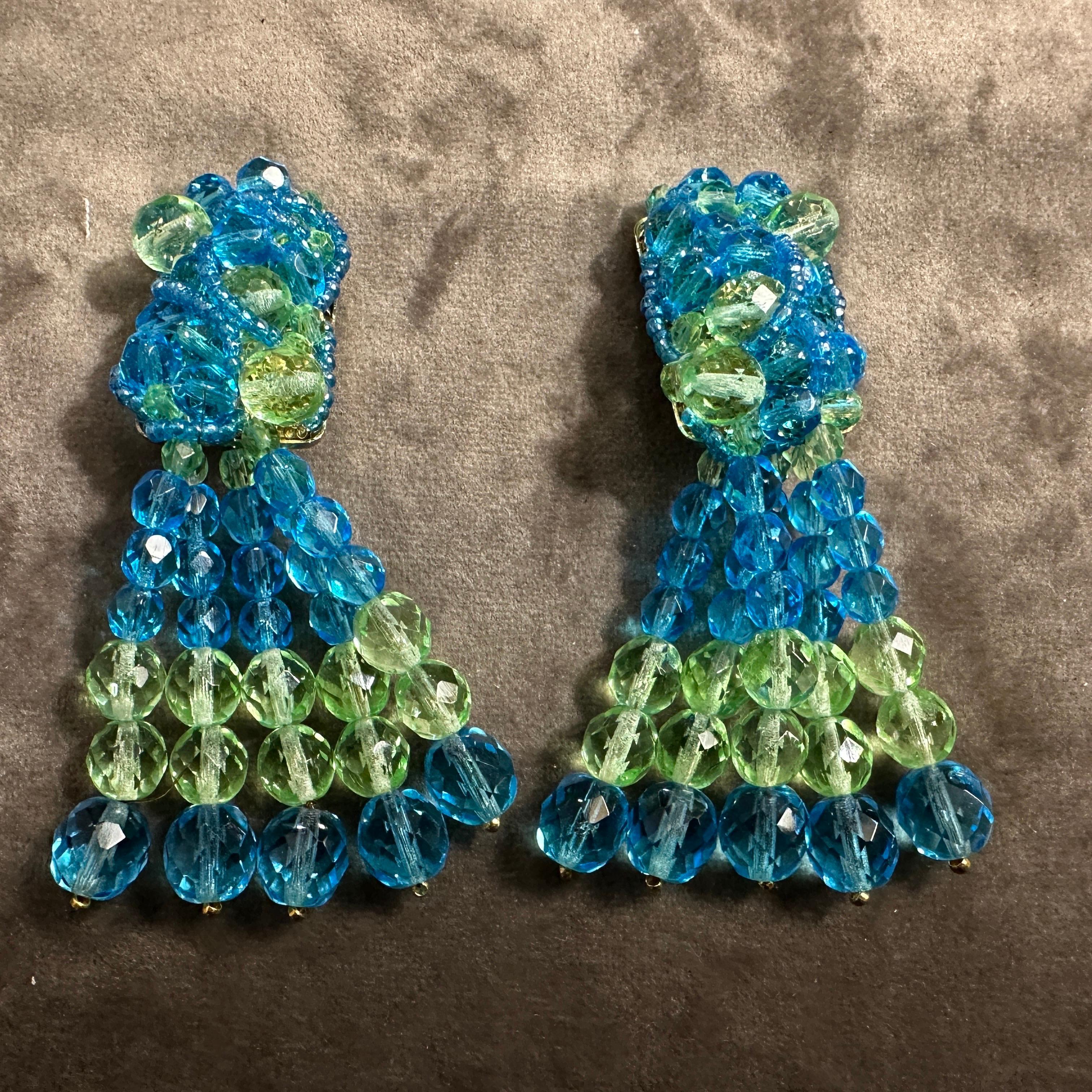 This elegant pair of earrings by Coppola e Toppo, crafted in the 21st century, exemplifies the brand’s mastery of beadwork and timeless design. These statement earrings feature a bold tassel structure made from meticulously hand-strung beads in