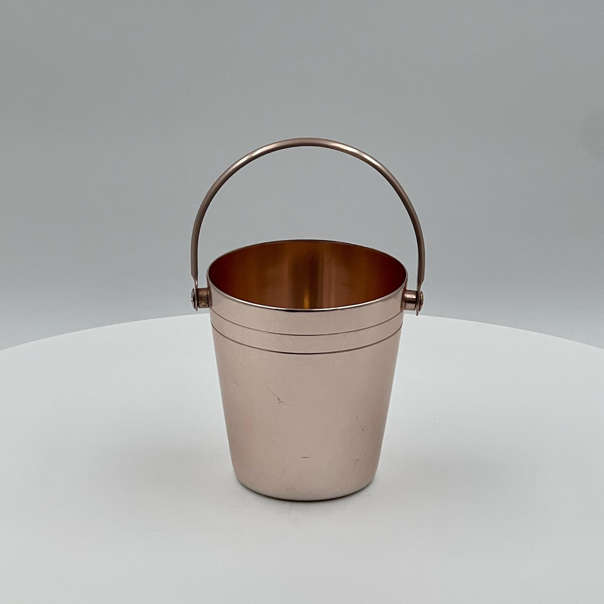 Dive into the retro charm of the Fifties with this iconic Ettore Sottsass‘ 50s Ice Bucket produced by Rinnovel. Crafted from anodized aluminum in a delightful shade of pink, this vintage piece exudes timeless elegance and sophistication.

Standing
