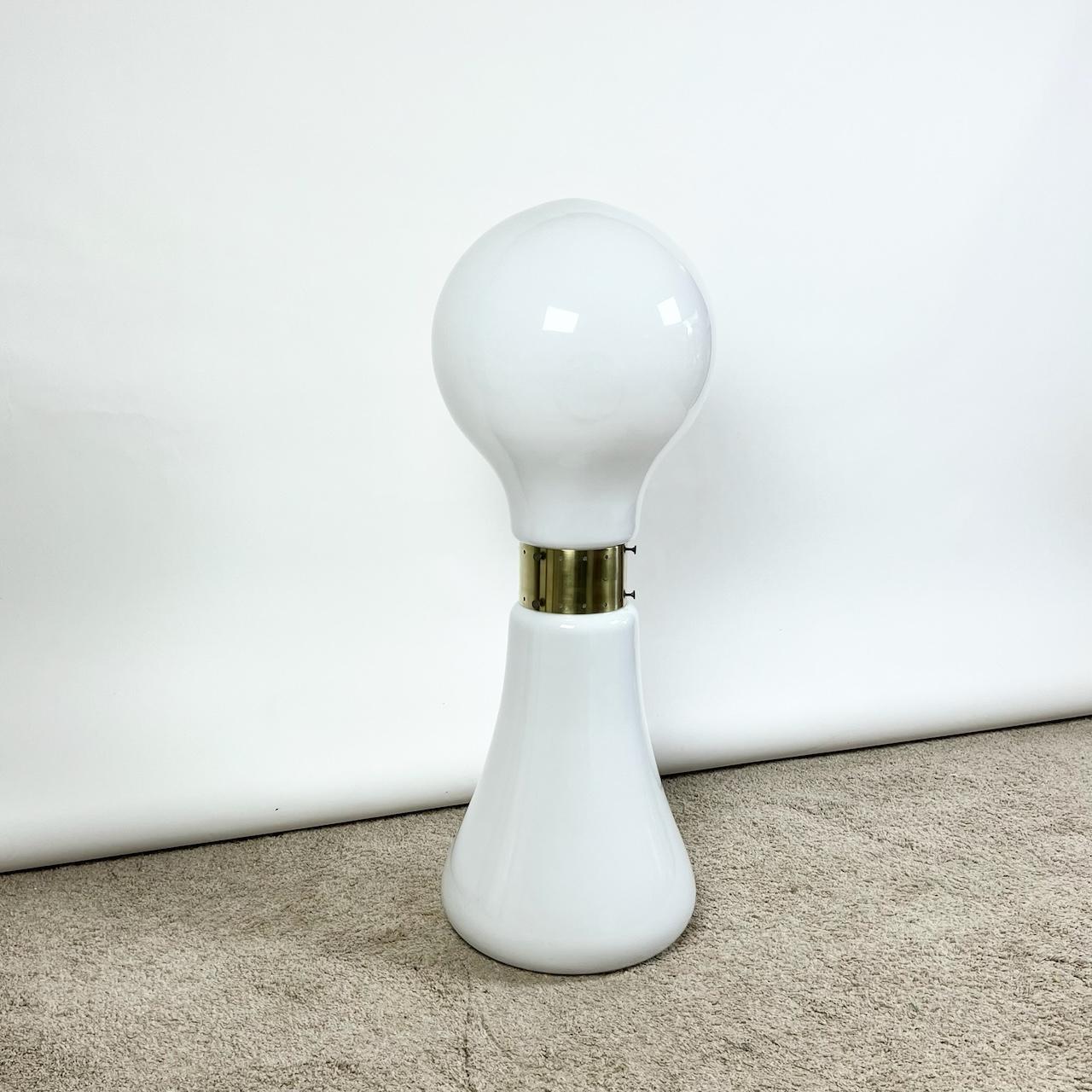 Step into the sophisticated world of mid-century modern design with the stunning ‘Birillo’ Floor Lamp from the 1970s. Crafted in Italy and attributed to Enrico Tronconi, this vintage 70s lamp showcases the unparalleled artistry of hand-blown Murano