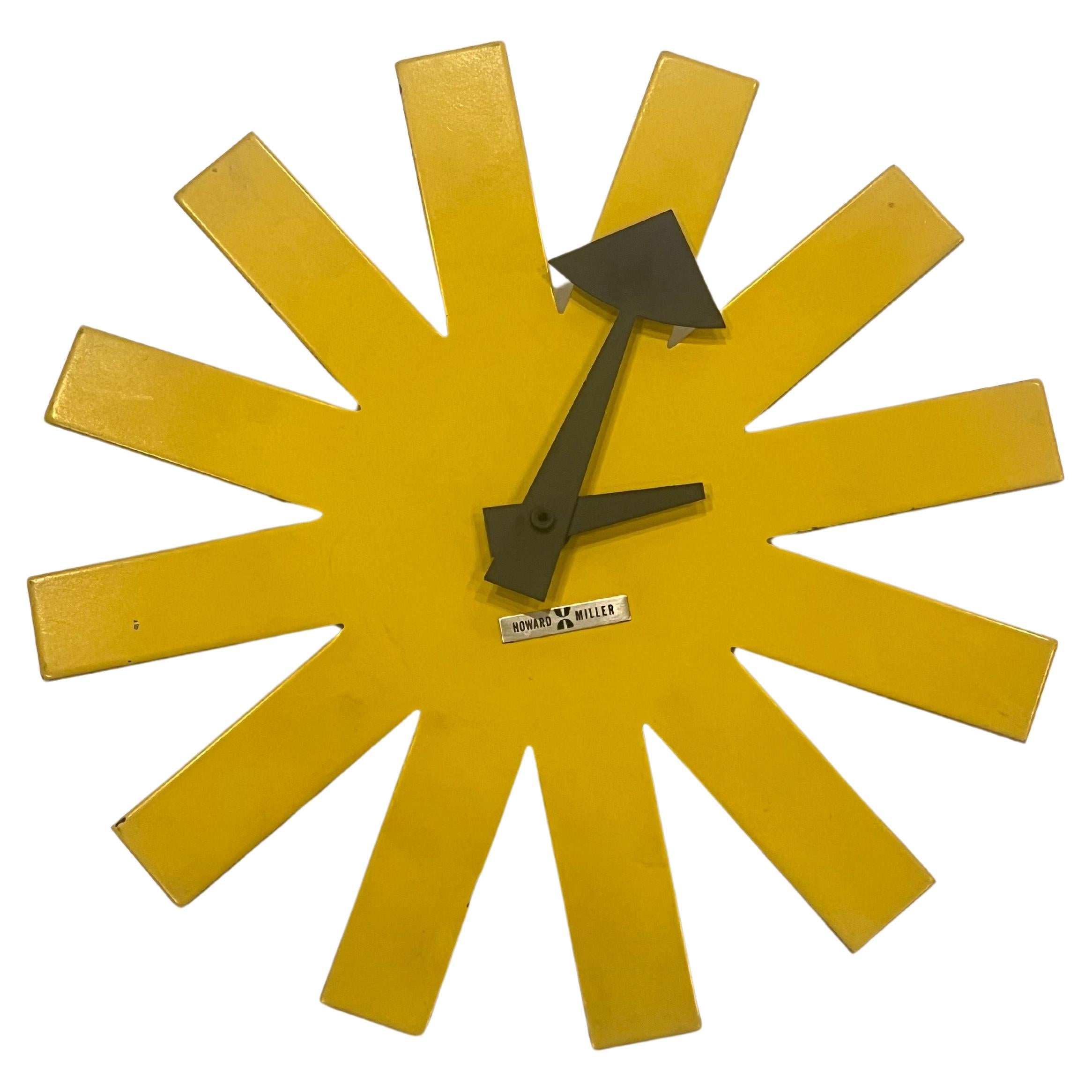 Iconic rare asterisk wall clock designed by George Nelson for Howard Miller circa 1970s, rare yellow color enameled metal battery operated movement very nice original condition.