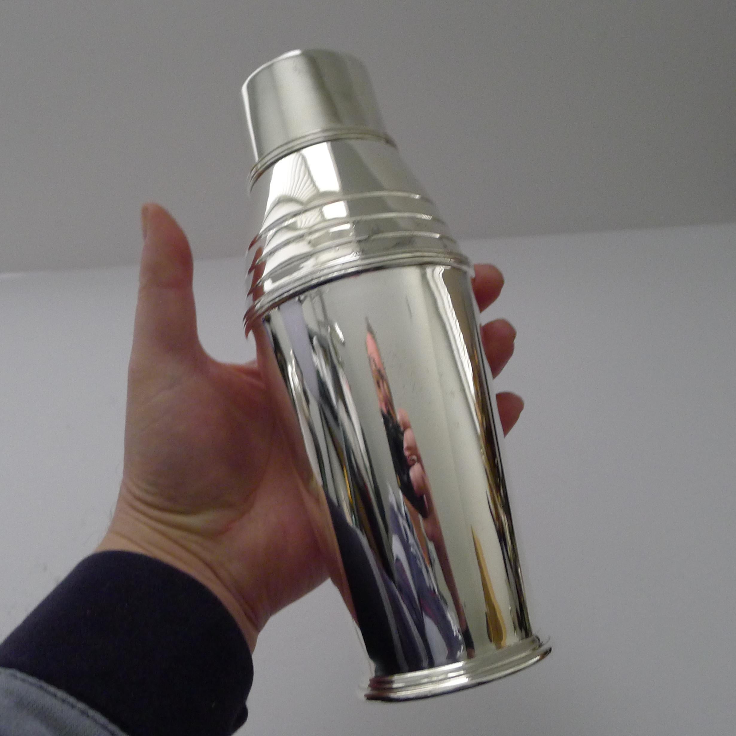 A striking silver plated cocktail shaker in a terrific Art Deco shape.

Just back from our silversmith's workshop where it has been professionally cleaned and polished, restoring it to it's former glory.

The underside is fully marked for the
