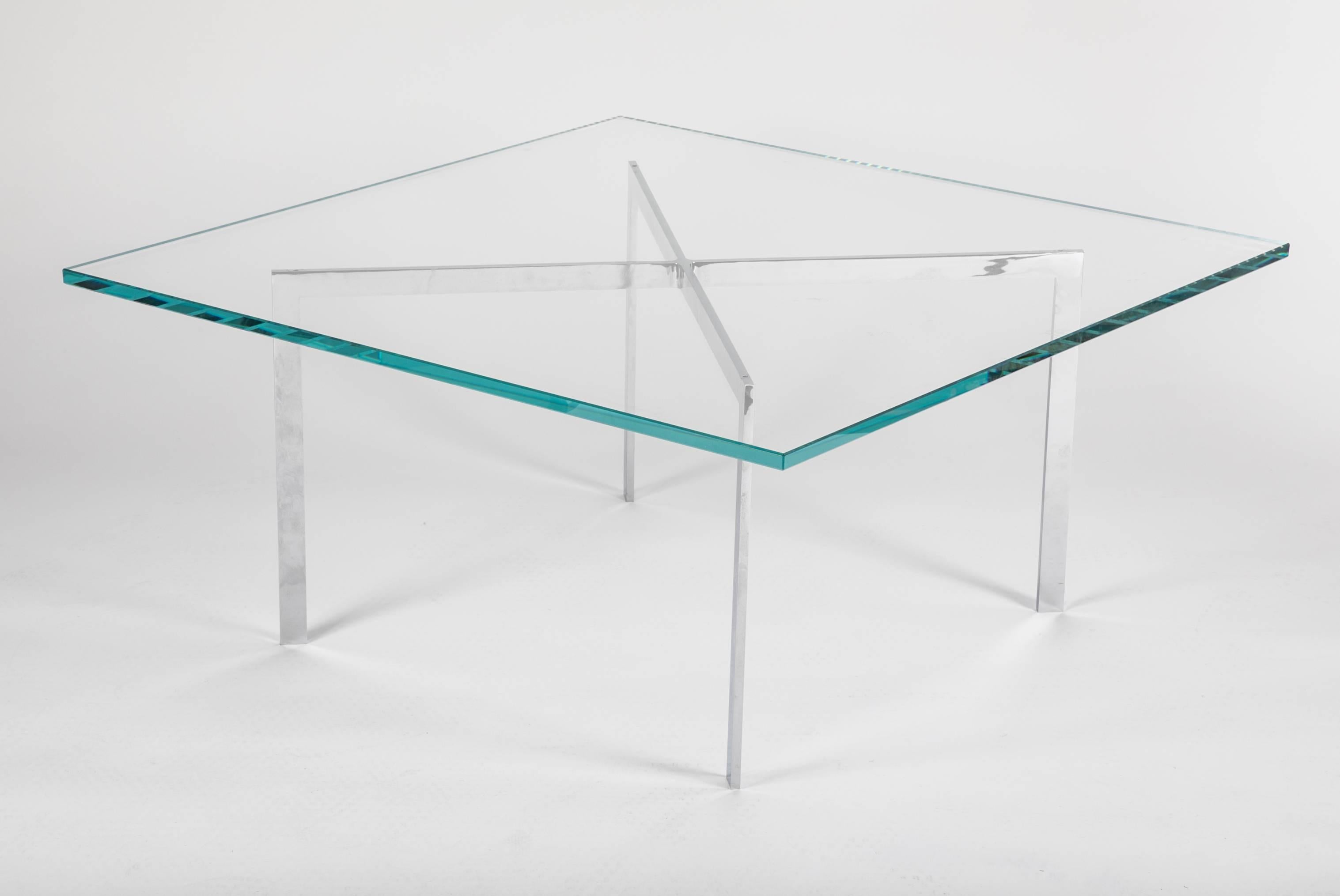 Iconic Barcelona coffee table with minimalist design, exemplary of the Bauhaus movement. Comprised of seamless architectural base with X form in polished chromed steel, with thick 3/4