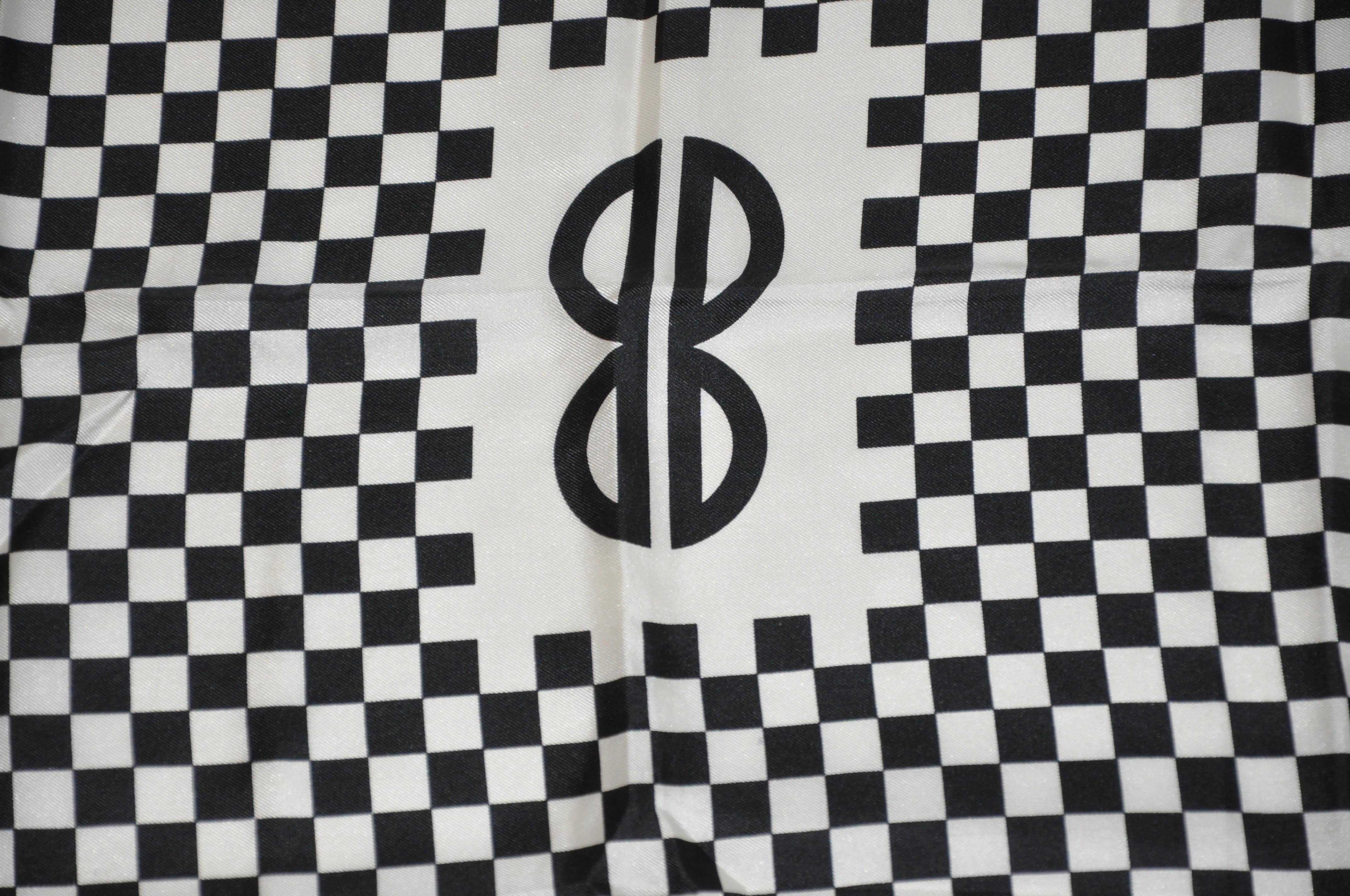        Iconic Bill Blass black & White checkered signature logo silk scarf measures 23 inches by 23 inches, with hand-rolled edges. Made in Italy.
