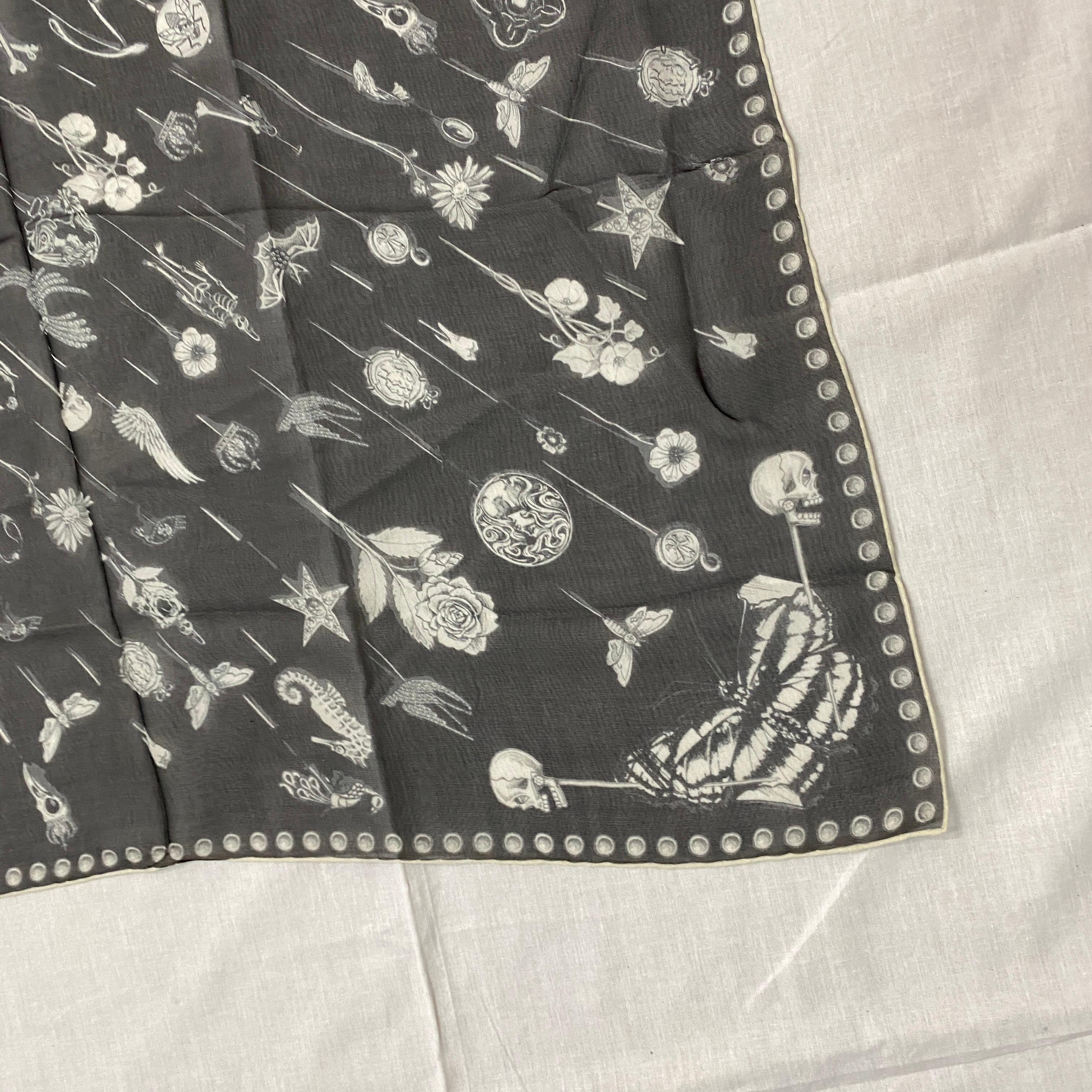 Iconic Black and White Silk Scarf by Alexander McQueen, with central Skull and other characteristic designs such as dragonflies and roses.
Dimensions 131 x 131 cm.