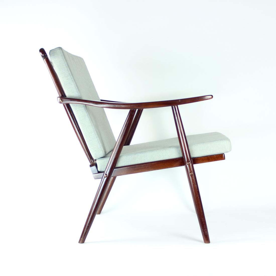 Iconic vintage armchair, also known as Booomerang armchair, produced by TON in 1960s. Original Thonet design. Produced by TON company in oak wood with beautiful bentwood details and craftsmanship. This armchair has been fully restored into a dark