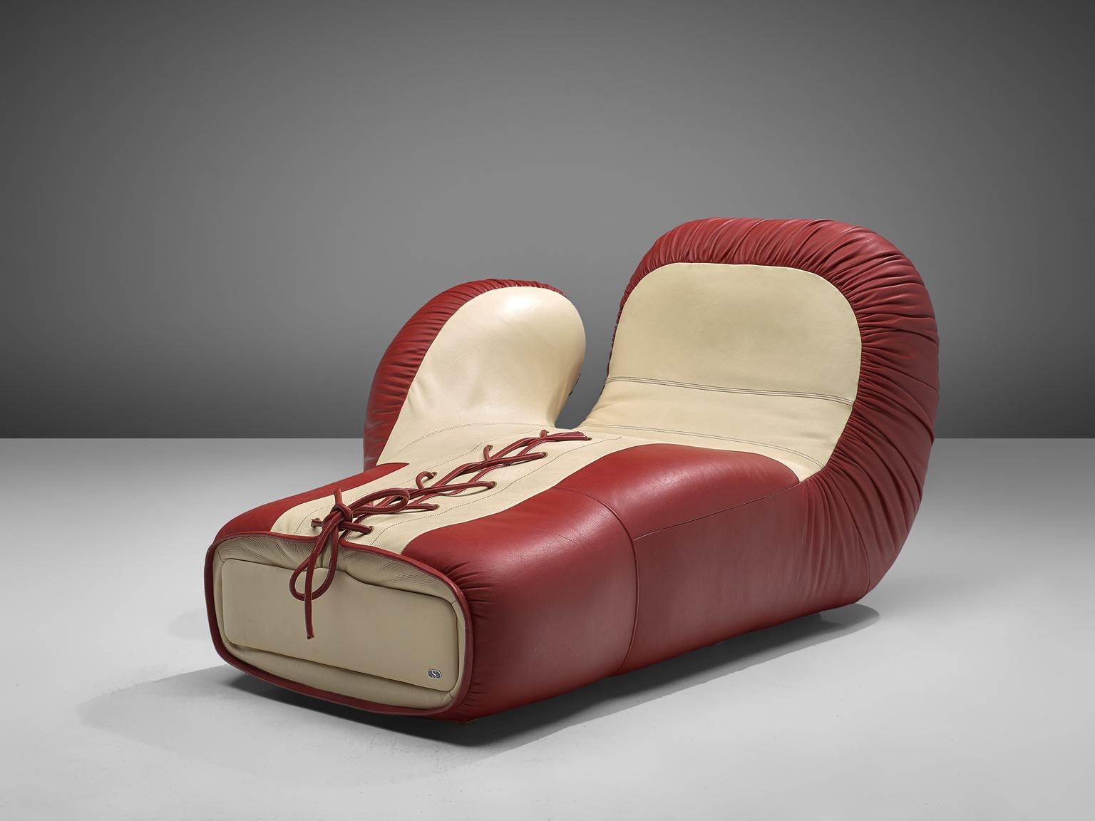 De Sede, boxing lounge chair, leather, Switzerland, circa 1975.

This large chaise longue boxing glove is designed by the De Sede design team. This piece is upholstered in a off-white and burgundy leather upholstery. This set is part of the older