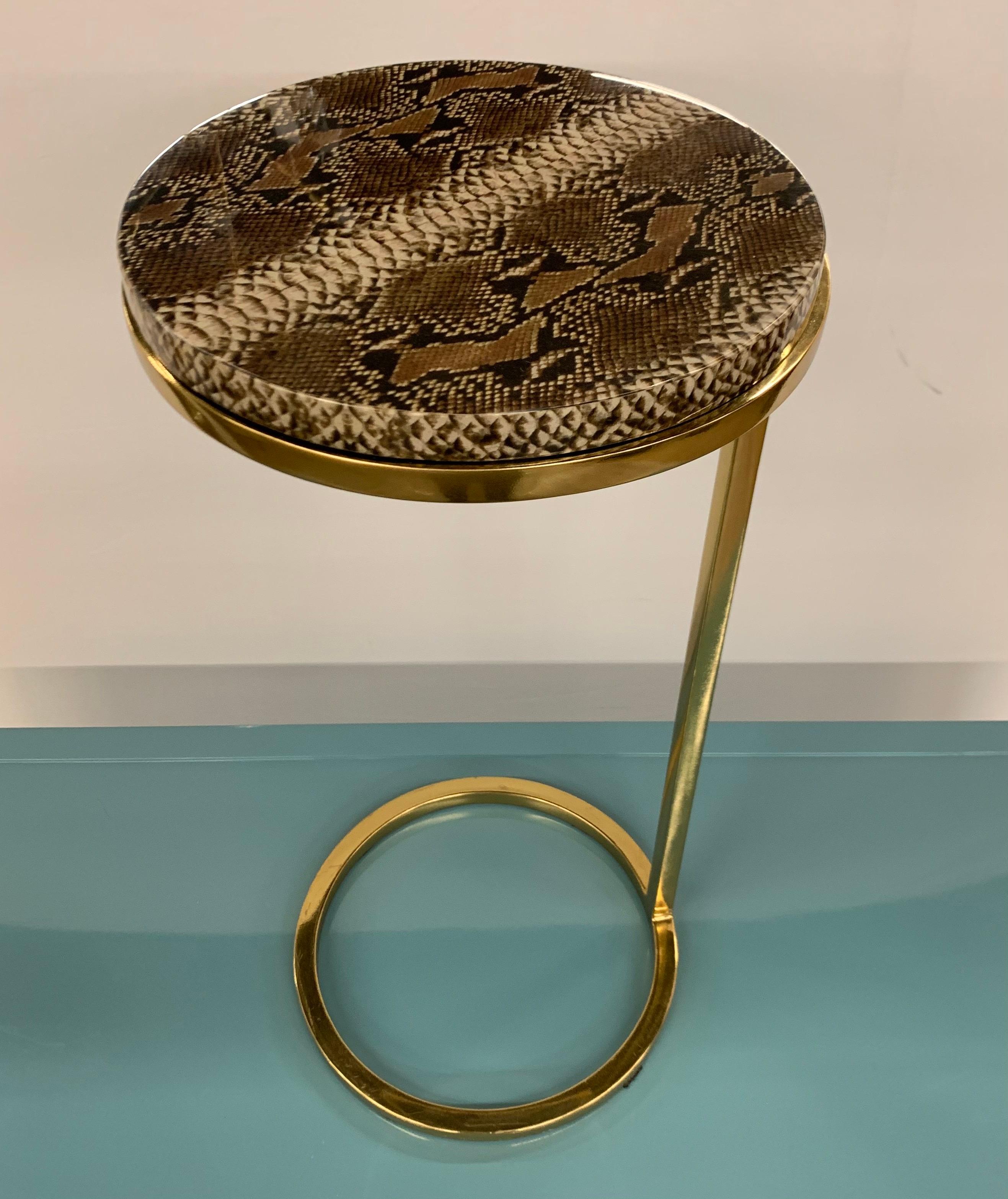 Elegant brass and snakeskin design on resin cigarette table with circular top. Great lines and better scale. Now, more than ever, home is where the heart is.