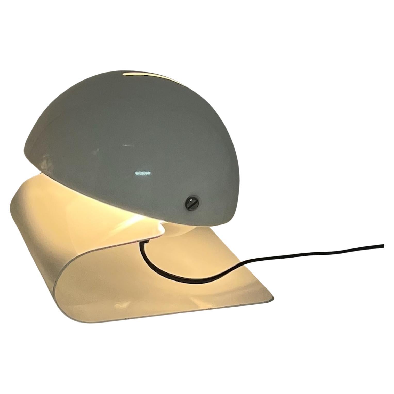 Iconic table lamp ‘Bugia’ designed by Giuseppe Cormio for Milano 1975 Fair and produced by Harvey Guzzini in 1976.

Bugia has a sleek, curved base made of a metal sheet with a tiltable half globe lampshade that allows to adjust the light. This piece