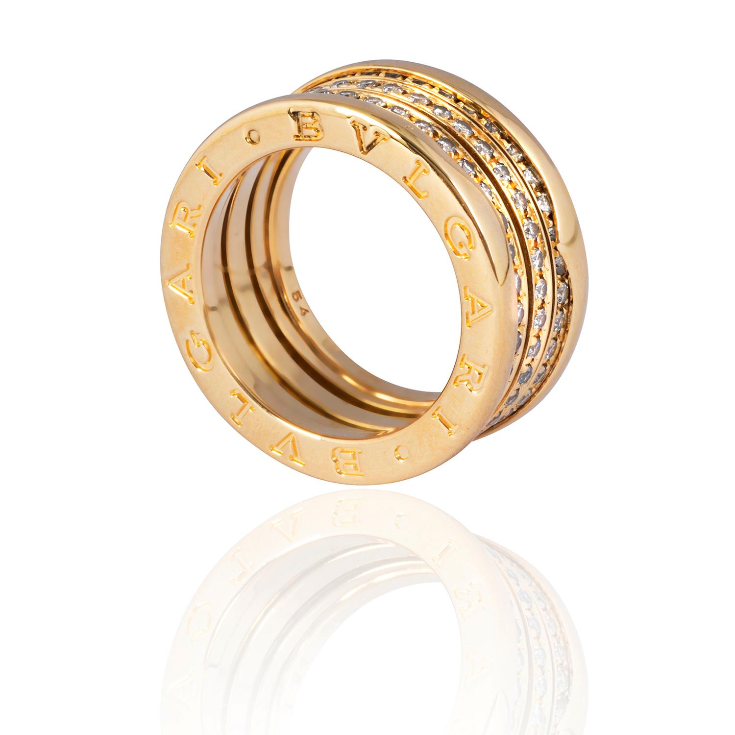 This iconic Bulgari statement ring features multiple sprung bands, set all the way round with glittering round brilliant cut diamonds.  With three central stone-set bands bordered by two polished gold bands, this is a broad ring measuring approx.