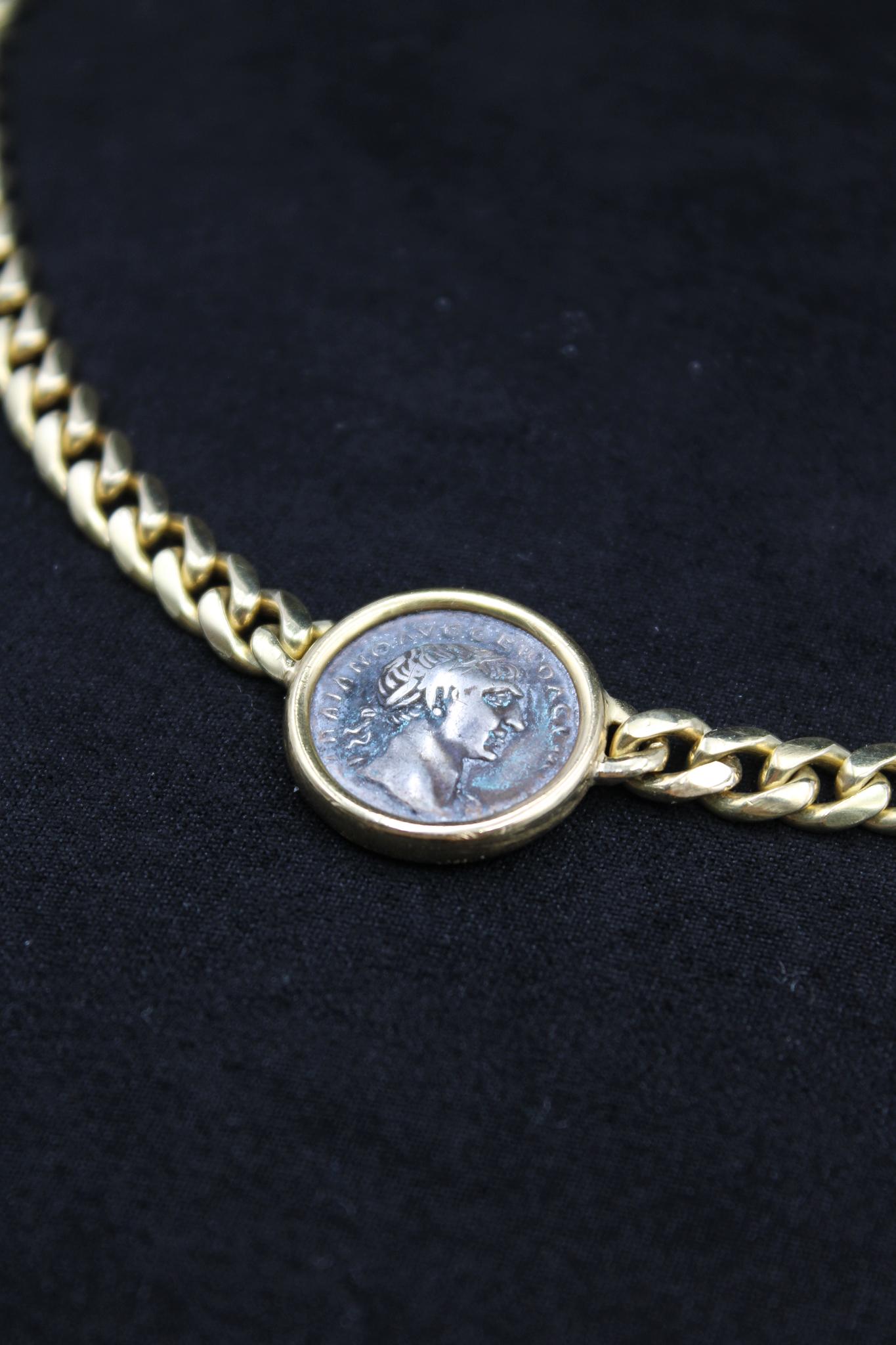 This striking Bulgari necklace is a rare and iconic piece from the legendary Monete collection, featuring an authentic ancient Roman silver coin depicting Emperor Trajan — one of the most revered rulers of the Roman Empire. Known for his military