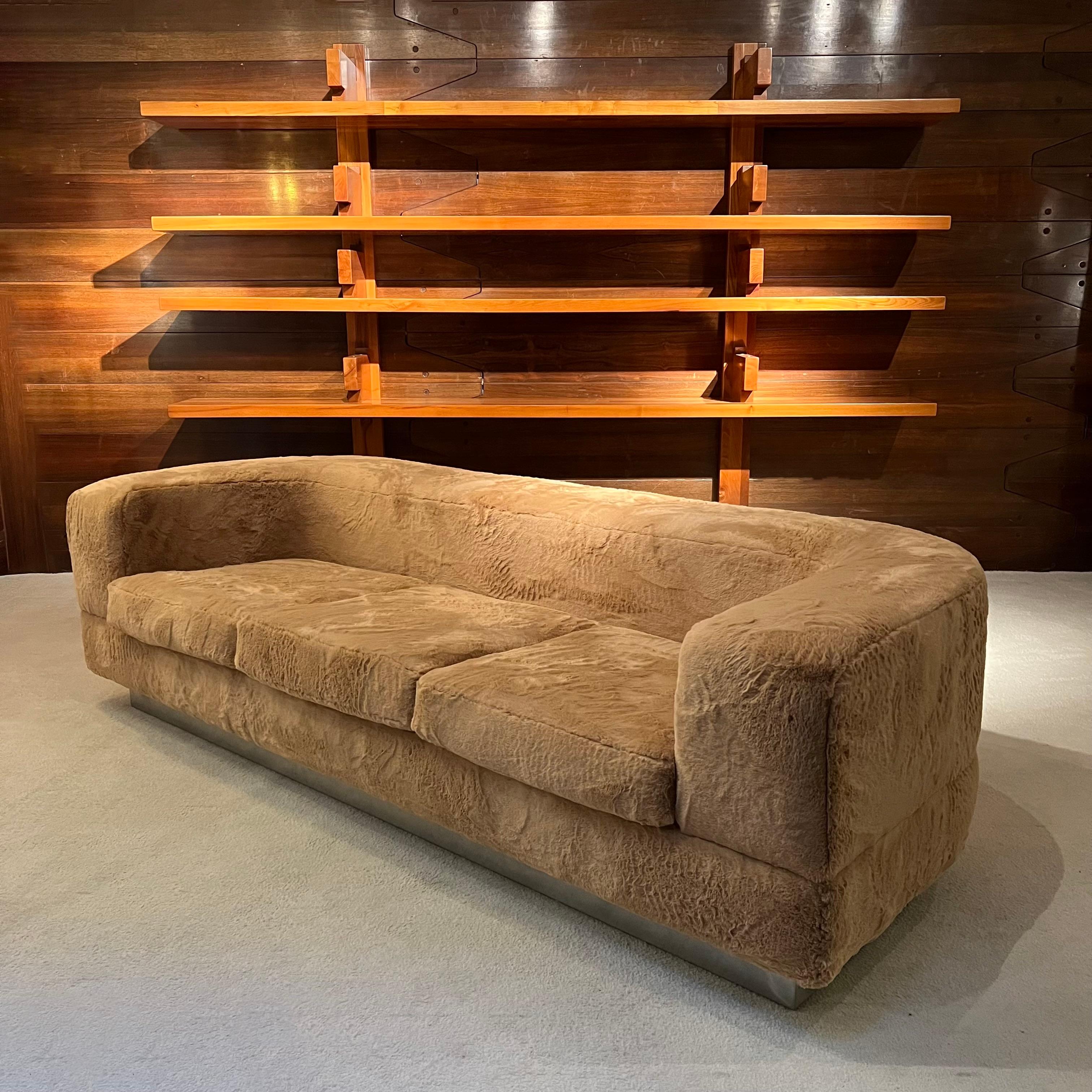 This iconic canape was designed by the French designer Jacques Charpentier, in France in the 70s.
The canape has been entirely reupholstered in faux fur. The base is a stainless steel plinth. 
Its classic shape makes it a model that can easily be