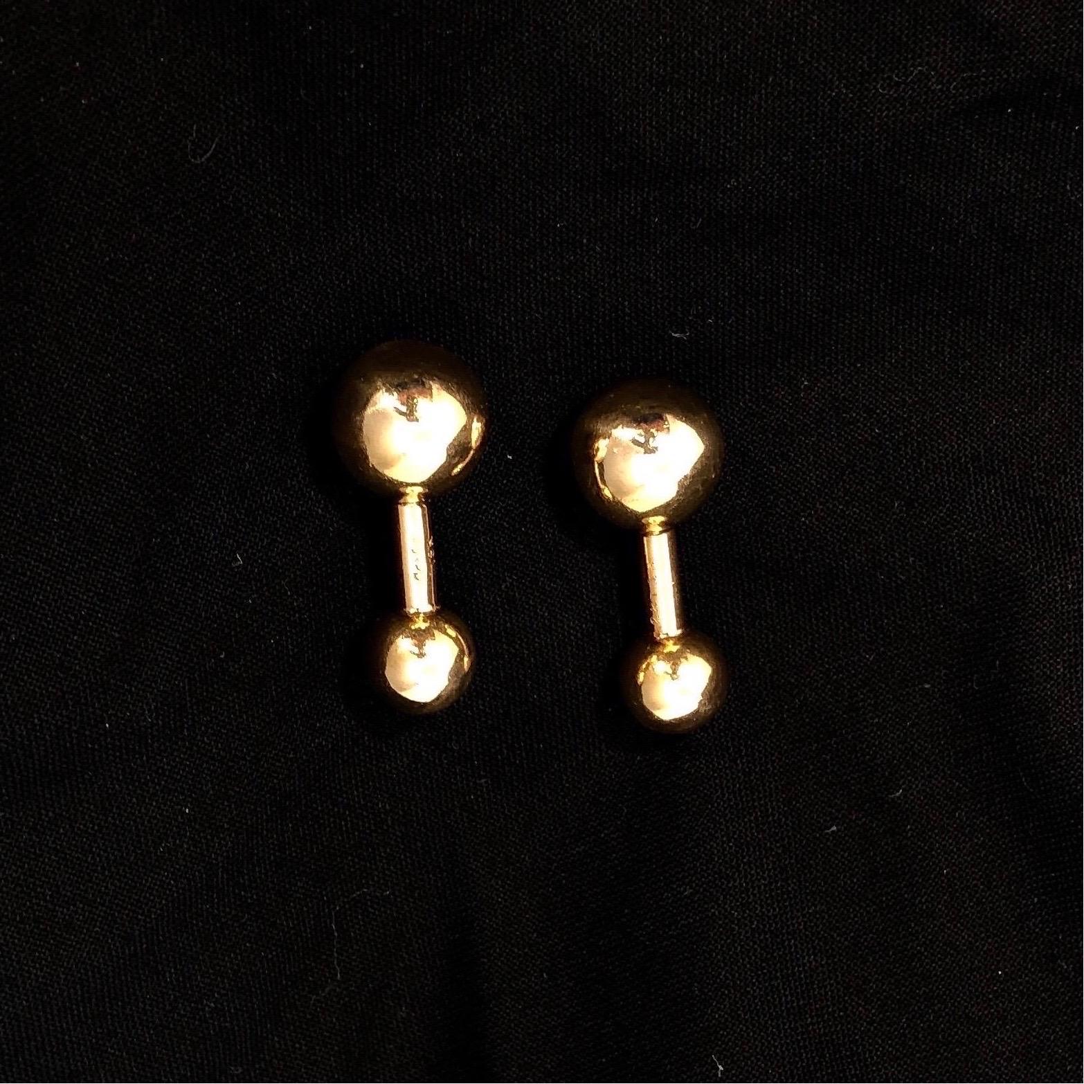These wonderful 18k yellow gold Cartier stud cuff links were created in the USA. Measuring 12.5mm and 9mm, the orbs are high polish finish and show a rich patina. The total weigh for the set of dumbbells is 11.3 grams and each is signed Cartier 18k