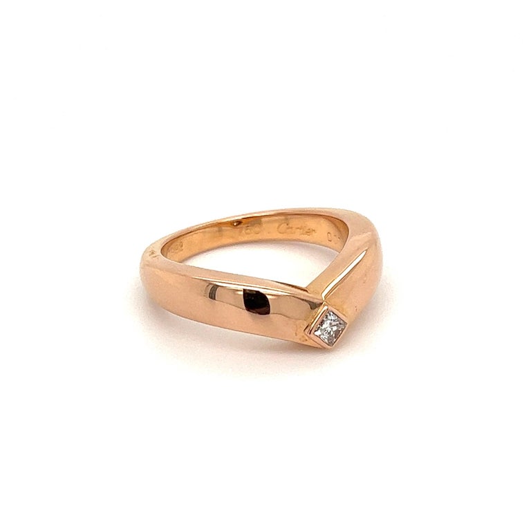Iconic Cartier! 18K Rose Gold V Band Ring. Ring size, 6.5, we offer ring resizing. Measuring approx. 0.90” x 0.87” x 0.28. Marked:  CARTIER DO7 643, 750. Chic and Classic… Ideal worn alone or as an alternative Engagement ring…illuminating your look