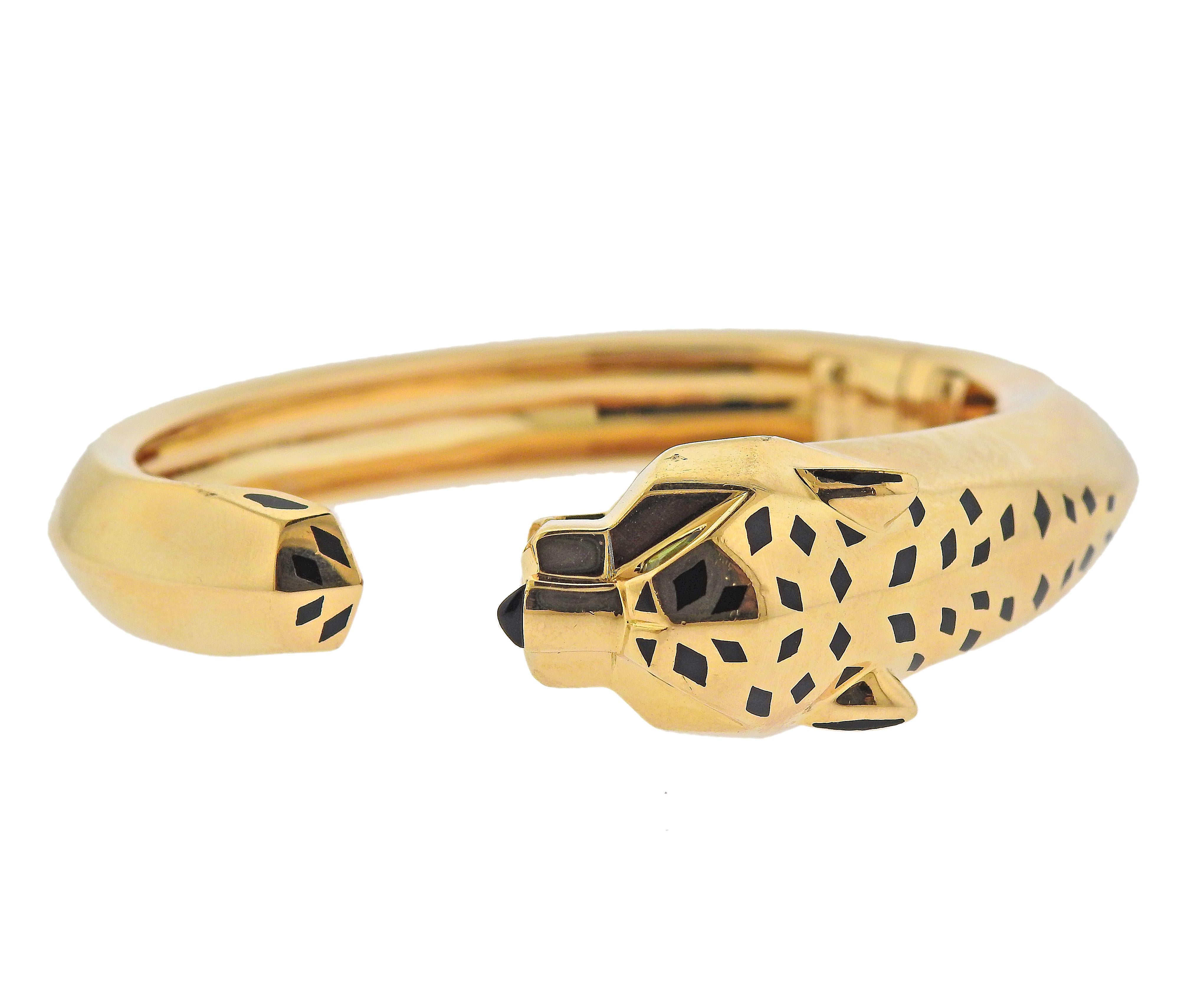 Cartier 18k rose gold iconic Panthere cuff bracelet, decorated with peridot eyes, onyx nose and enamel top. Bracelet will it an average size wrist, approx. up to 7.5