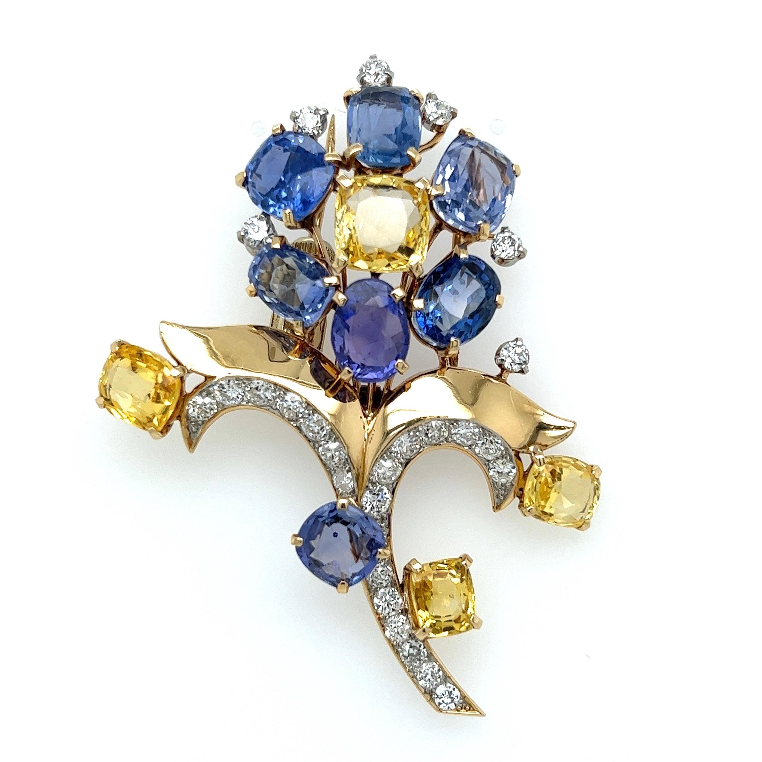 Simply Beautiful! Stylish and finely detailed Mid Century Modern CARTIER Blue and Yellow Sapphires and Diamond Floral Brooch Pin. Securely nestled, Hand set Center Yellow Sapphire 9.3x8.8x5.2mm approx. 4.25ct. Blue Sapphire 11.1x7.3x5.40mm, approx.