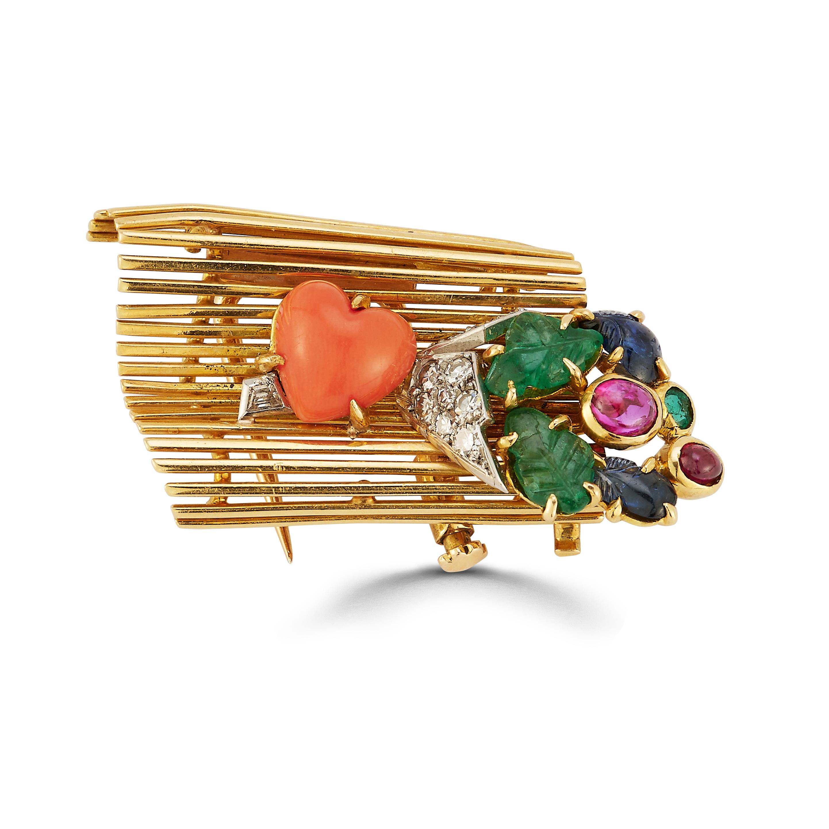Iconic Cartier Tutti Frutti Lovers Bench Brooch

An 18 karat yellow gold brooch in the design of a garden bench adorned with a bouquet of flowers. The bouquet is set with 11 round cut diamonds, 3 carved emeralds, 2 carved sapphires, 2 cabochon