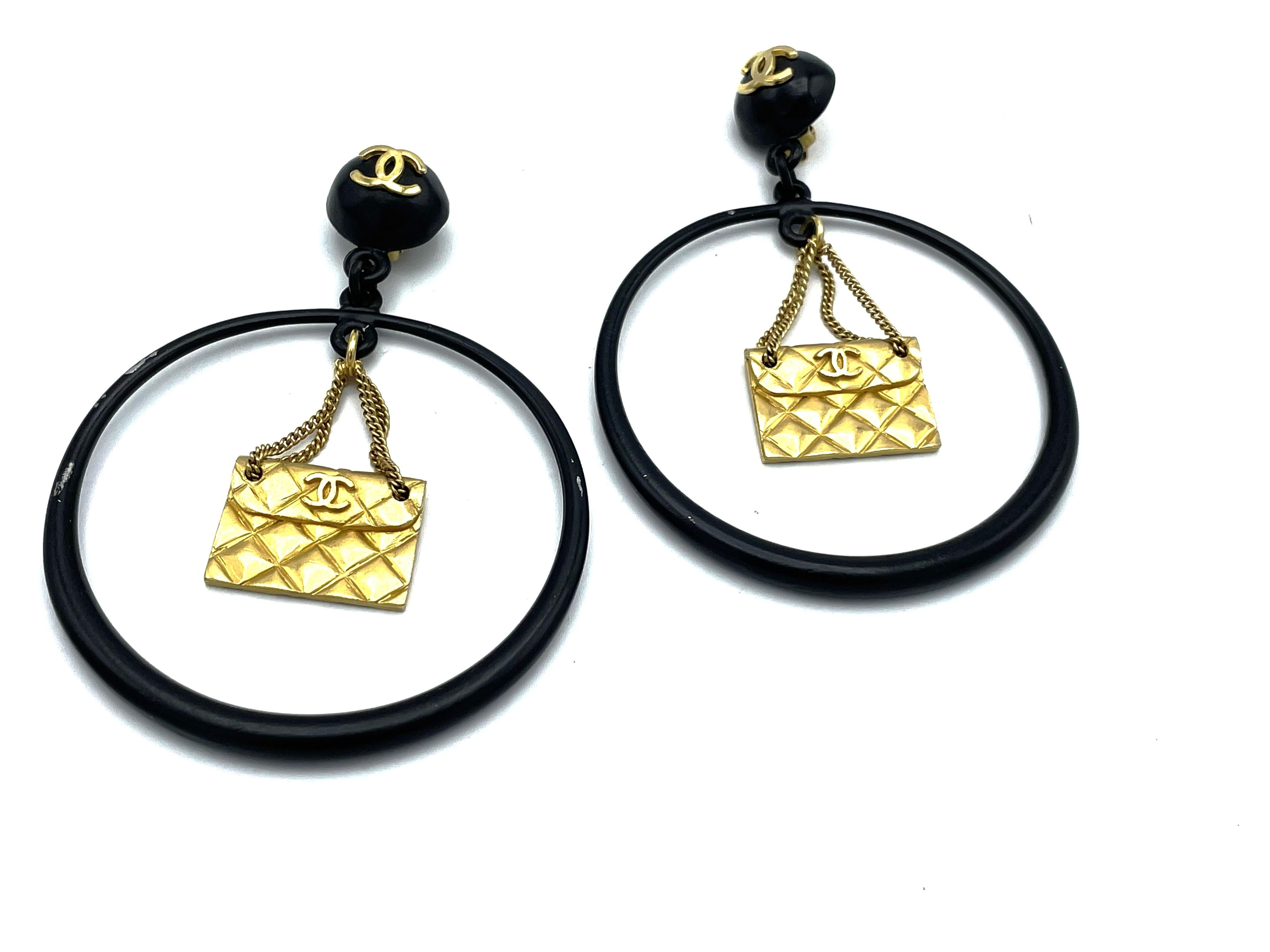 Women's Iconic Chanel black Circle clip-on earring with gold Chanel bag hanging, 1990s For Sale