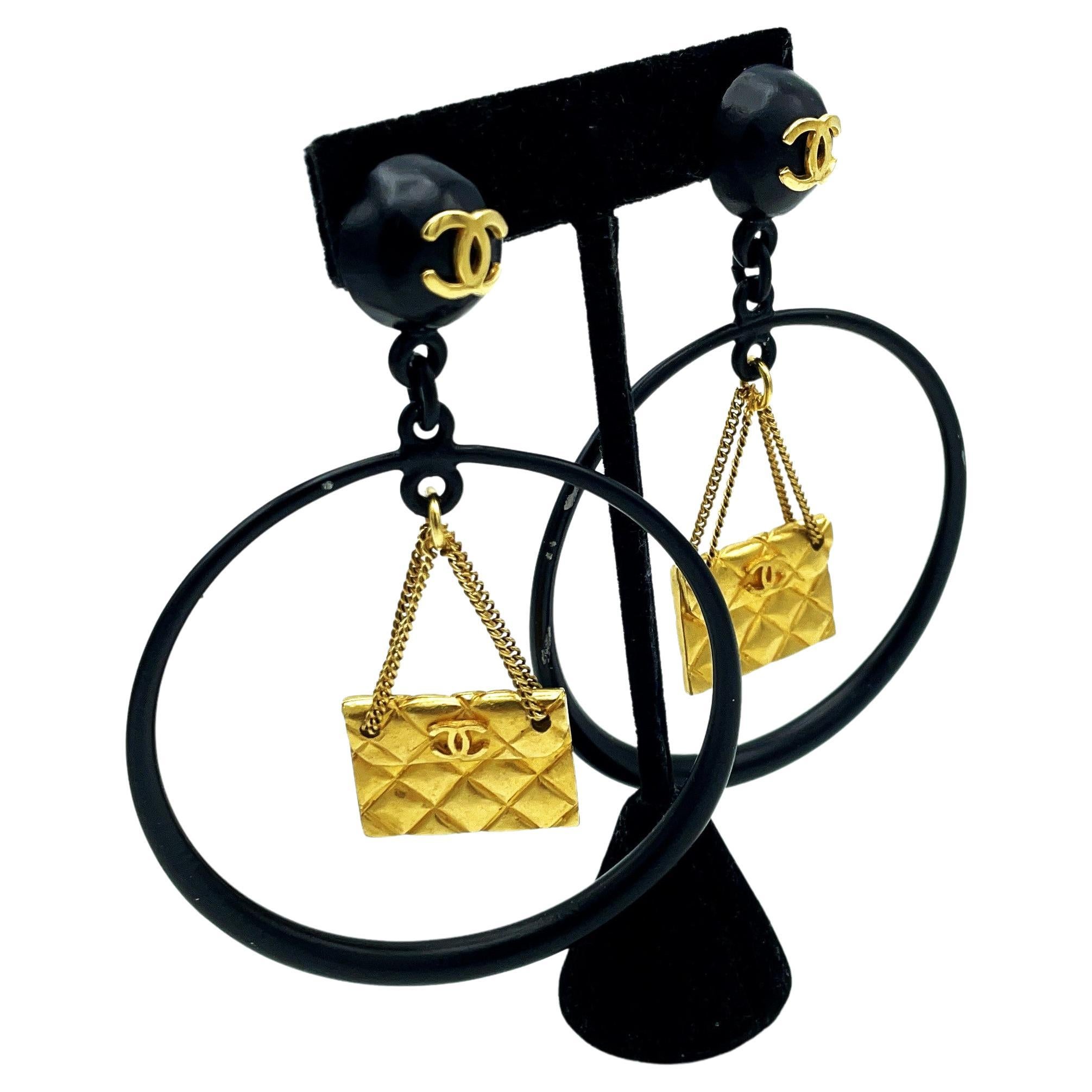 Iconic Chanel black Circle clip-on earring with gold Chanel bag hanging, 1990s For Sale