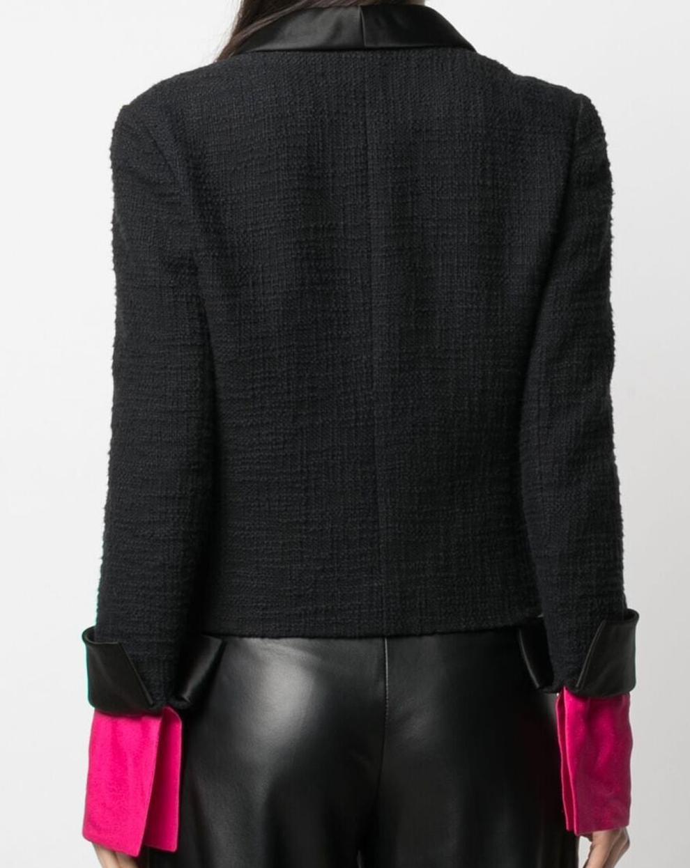 Chanel Black boucle cotton tweed jacket Paris-Bombay Metiers d Art Autumn 2012 featuring a silk satin shawl collar, pink silk detachable cuff details, green jewel fancy decorative buttons, hook closure, a logo silk lining, a gold tone inside chain.