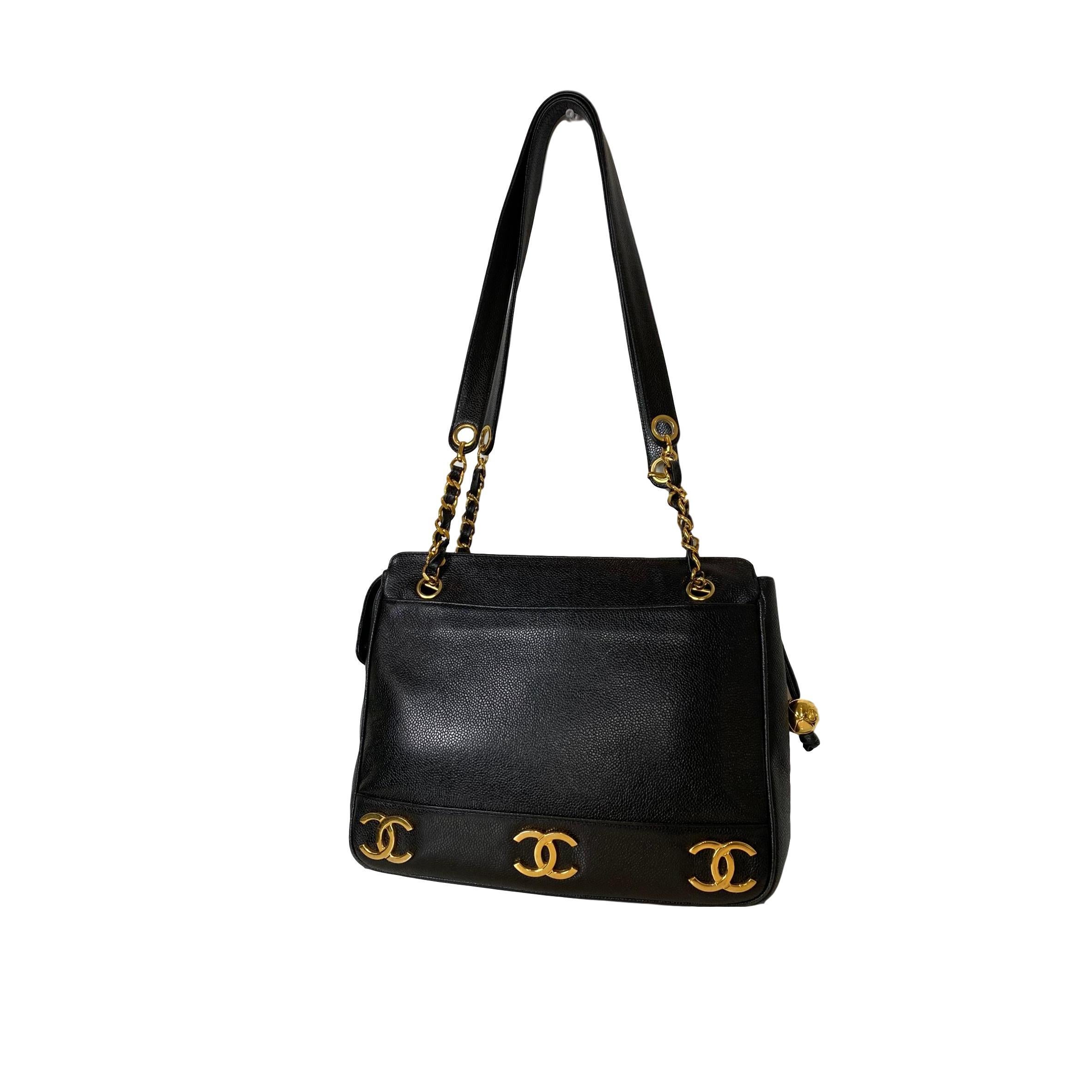 A rare and vintage 1994 Chanel Triple Logo Leather Shoulder Bag in black caviar leather and lambskin, adorned with three 24K gold-plated iconic 'CC' Logos on both sides of the bag.  The Chanel logo, arguably the most recognized logo in the world,