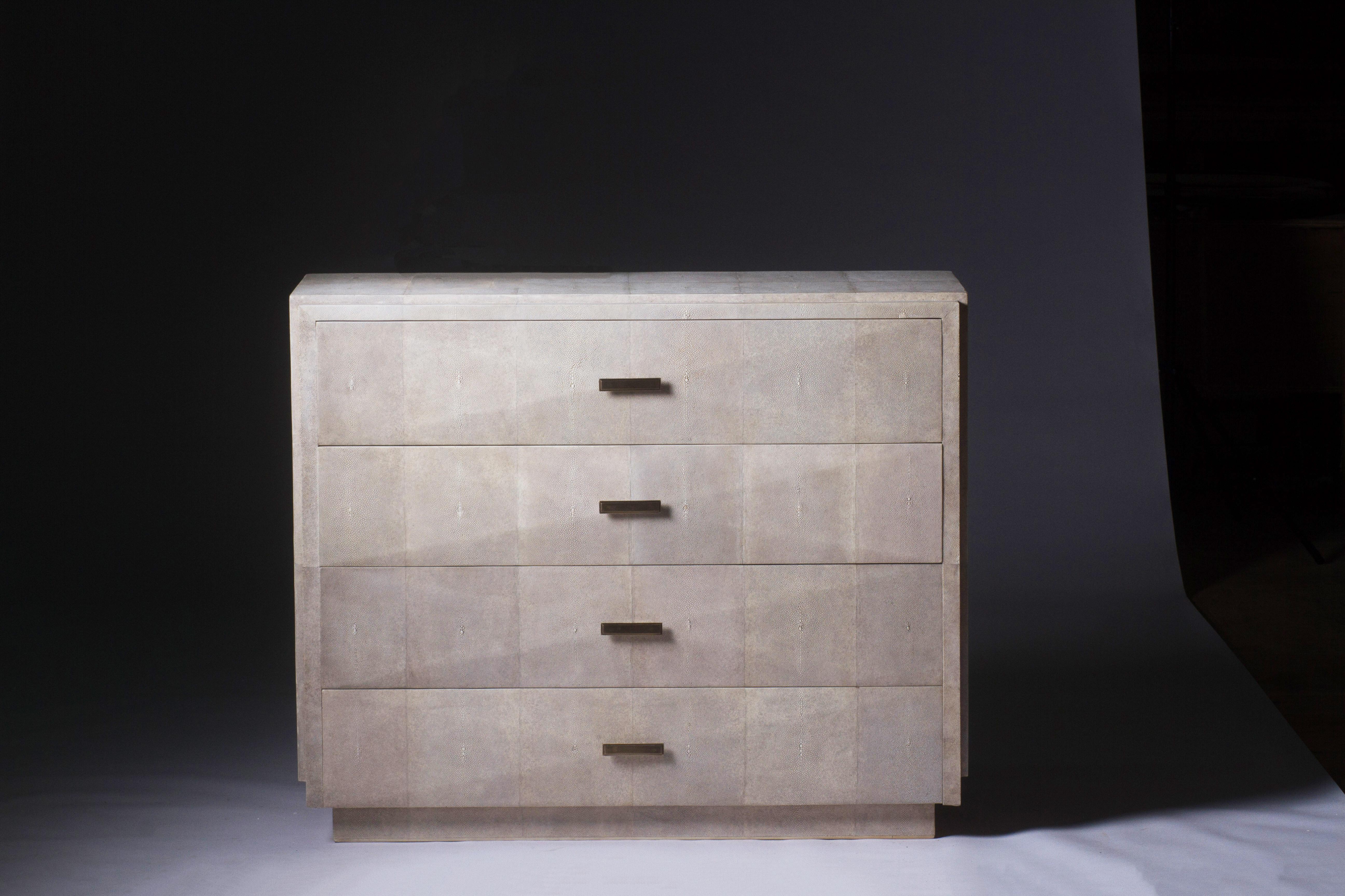 The iconic chest of drawers by R&Y Augousti is one of their first designs. A Classic and functional storage piece, with subtle geometry on the beveled drawers. This chest of drawers is completely inlaid in cream shagreen with discreet bronze-patina