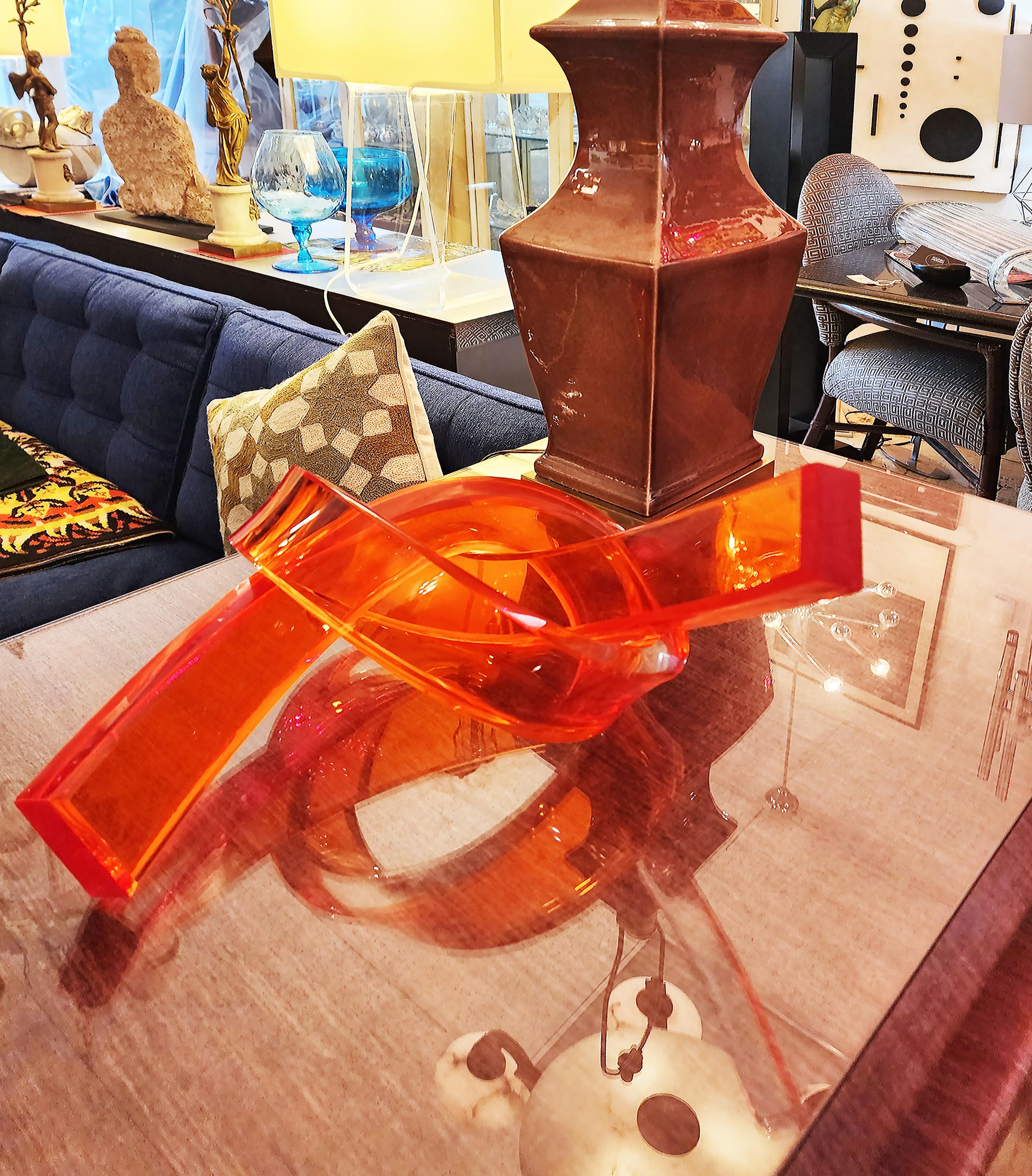 Iconic Design Thick Twisted Abstract Lucite Ribbon Sculpture, 2023

Offered for sale is a new 1-inch thick Lucite bi-color orange and clear twisted abstract table sculpture. The colors are laminated and create interesting results when viewed from
