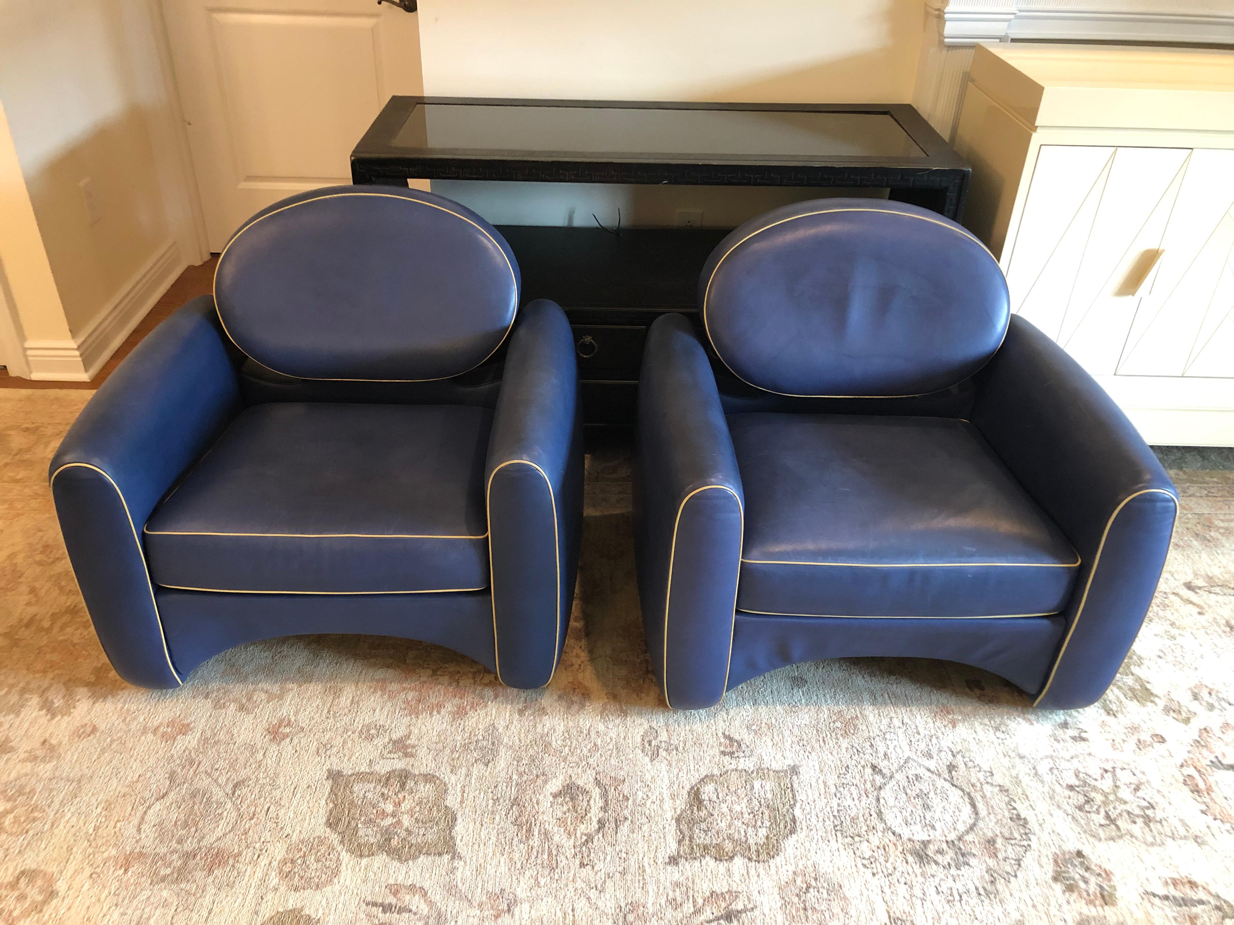 Iconic Mid-Century Modern leather Osaka club chairs for De Sede designed by very collectible Belgian artist, Emiel Veranneman. The fabulously shaped chairs are a gorgeous shade of blue leather with tan piping.

Measures: Seat depth (front to back)