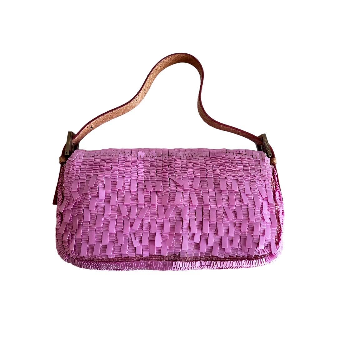 Introducing the Vintage Fendi Pink Sequin Baguette - a highly sought-after bag that exudes classic and timeless elegance. With its beautiful condition that is hard to come by, this bag is a must-have for any fashion enthusiast. Embrace luxury and