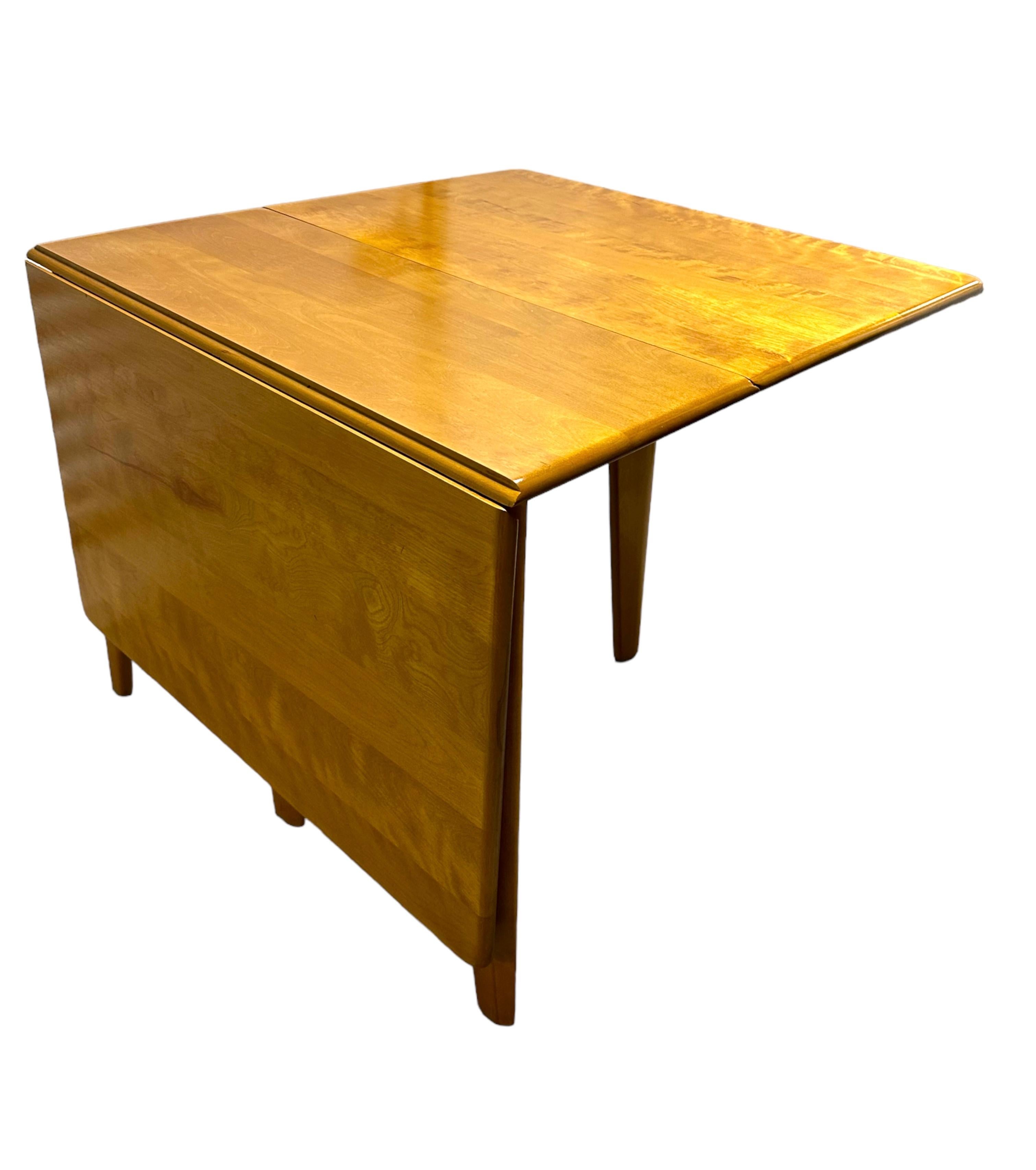 Wonderfully crafted vintage dining table by the iconic Heywood Wakefield. A drop leaf design makes this s highly functional table for small urban home or a small eating area in a large estate, can be used as a desk or visual accent as well. Very