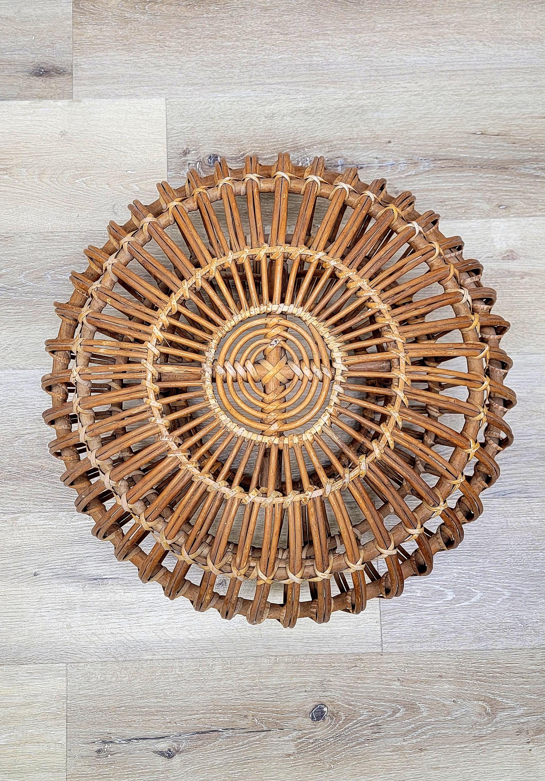A vintage rattan round pouf designed by Franco Albini in the 1950s and manufactured by Vittorio Bonacina in the 1960s. An ingeniously designed stool that's composed solely of bent-rattan weaving makes for a Classic and stylish piece. Made of