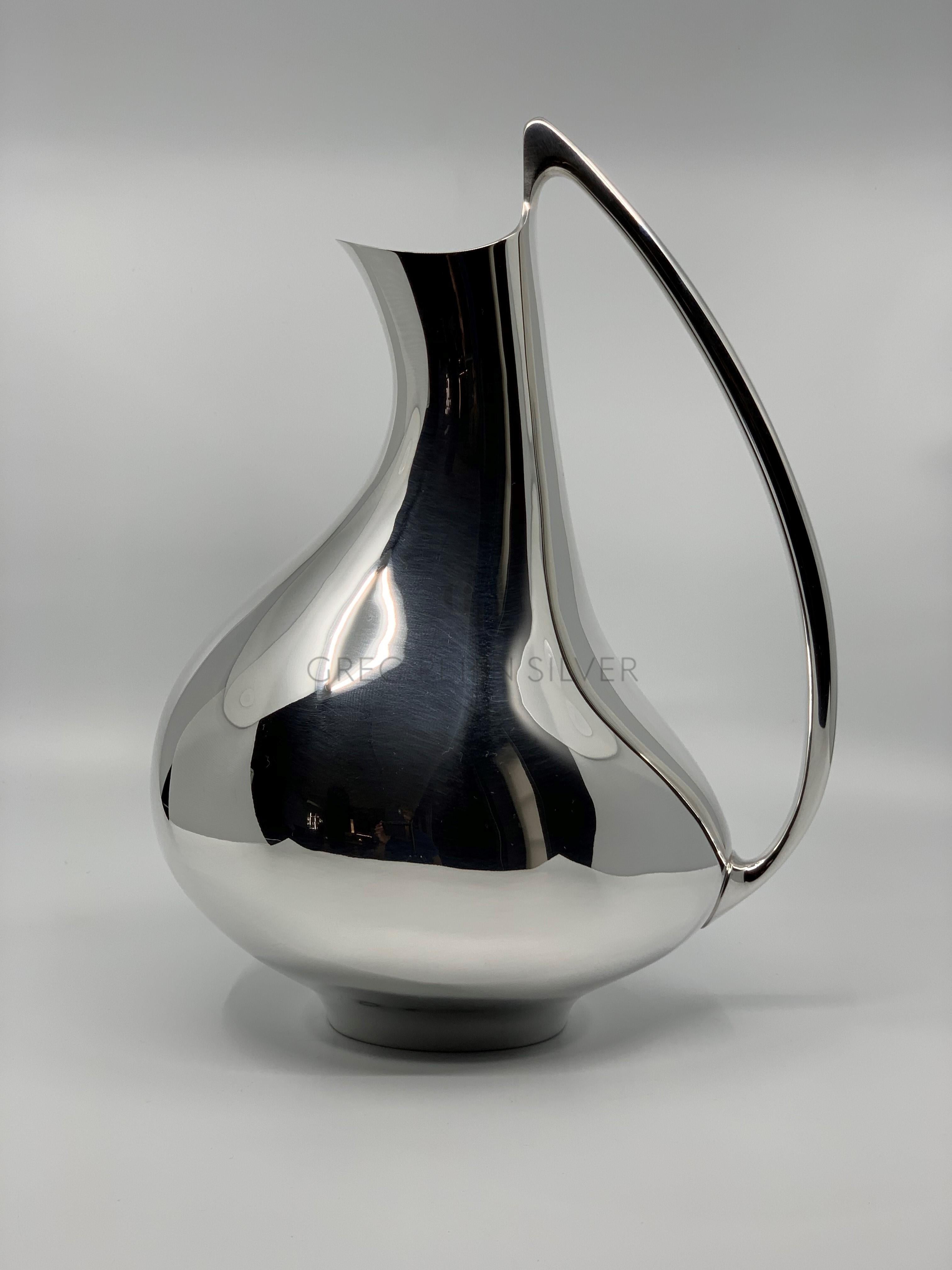 A modern sterling silver Georg Jensen pitcher, design #992 by Henning Koppel from 1952, known as the 