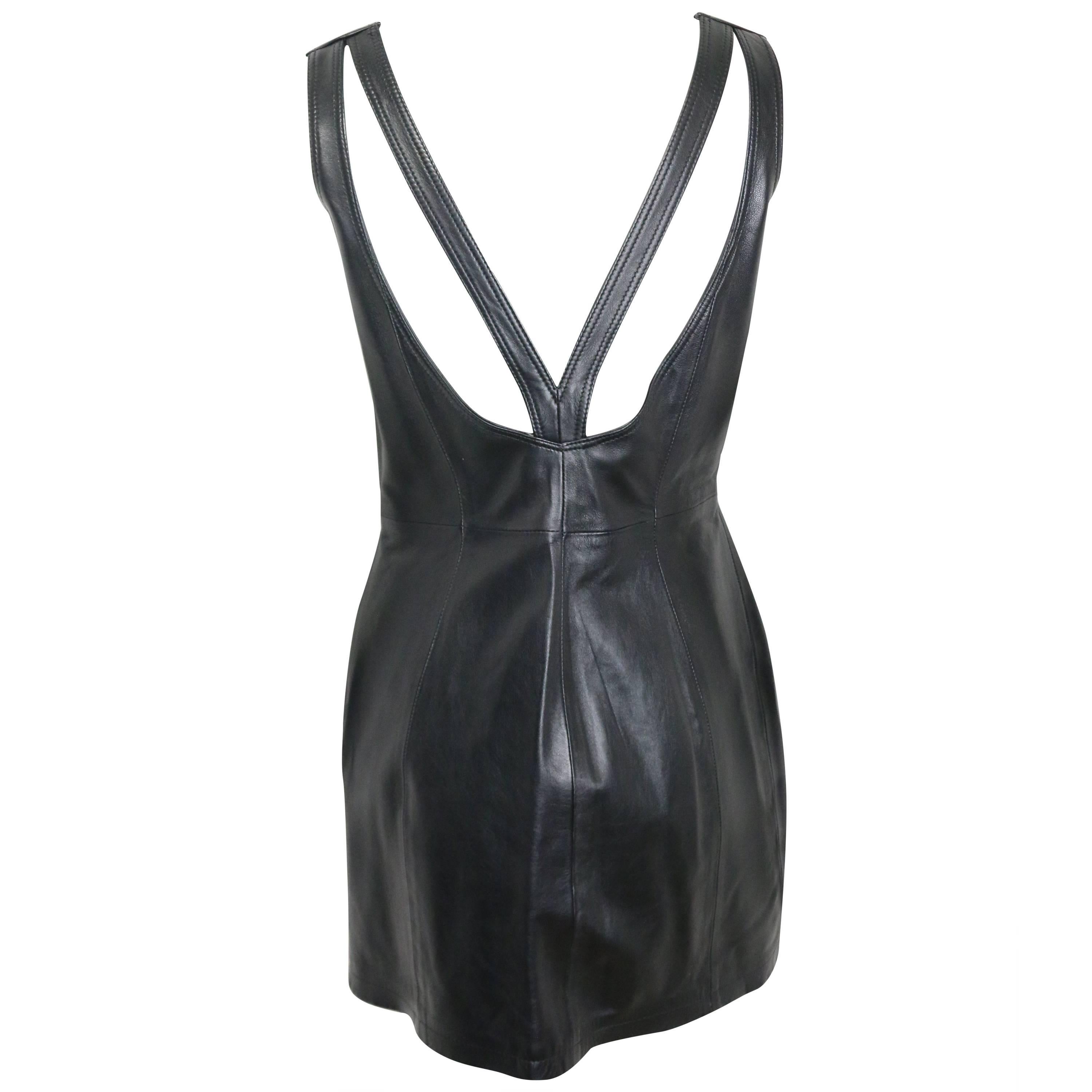 - Vintage 90s Gianni Versace iconic black leather back cut out dress. 

- Featuring a V- shape straps at the back and round neck in front. 

- Side zipper closure. 

- Made in Italy. 

- Size 33/40. 

- Shoulder: 13 inches. Bust: 30 inches. Height: