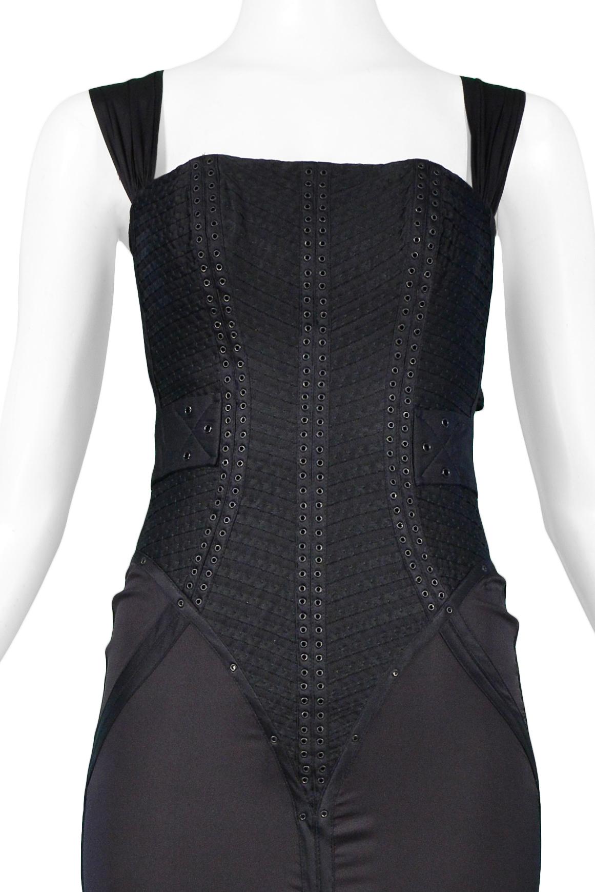 We are excited to offer this stunning vintage black Tom Ford for Gucci silk corset gown featuring a heavily pleated corset bodice with grommets, criss-cross back straps, pleated insets, grommet trim, gown length with train, center back zipper, and