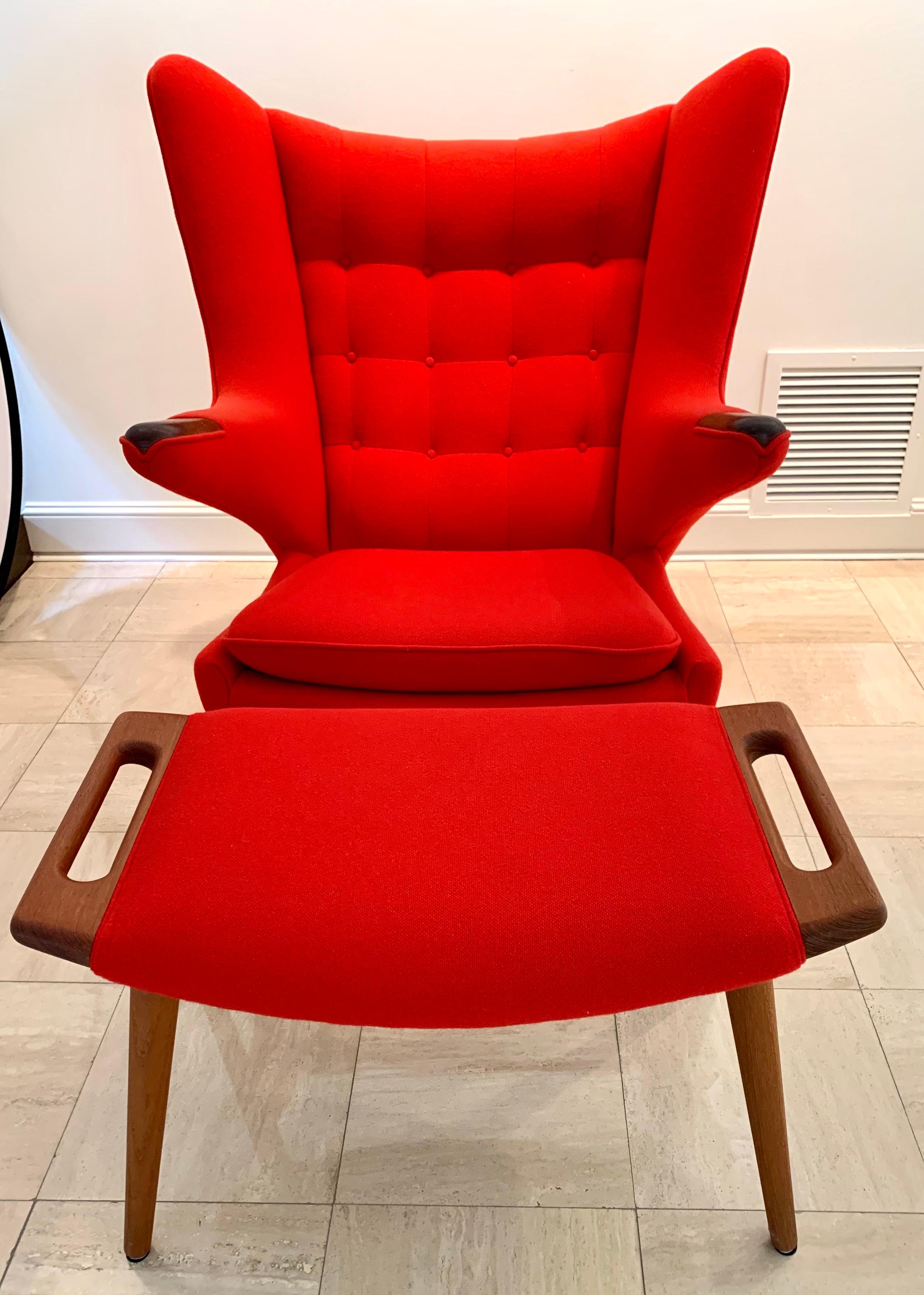 One of Wegner's most iconic designs. Great condition and done in a vibrant red fabric. Rare to see the chair and ottoman combo.

The wingback Papa Bear chair, also known as the Teddy Bear chair, has two outstretched arms with wood detailing once
