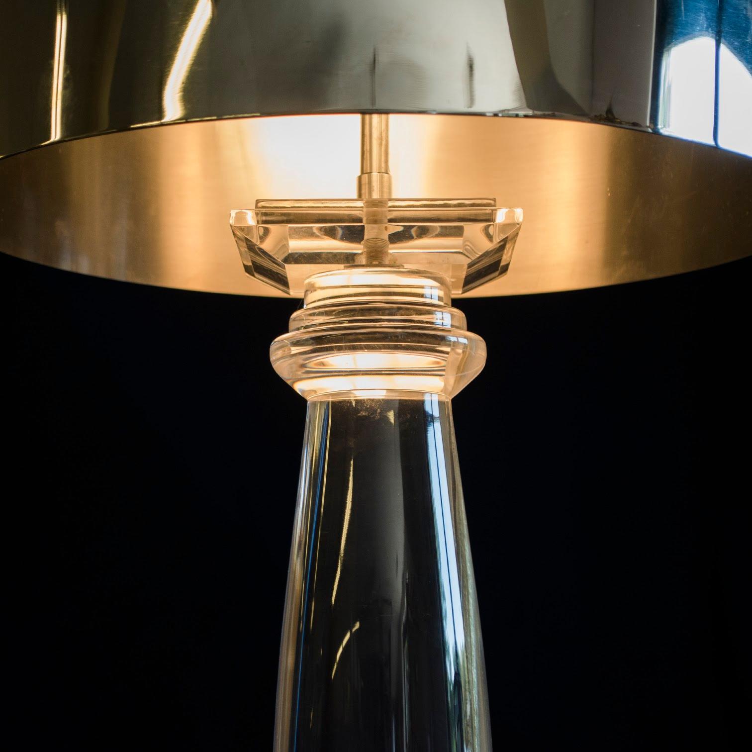 Iconic Karl Springer lamps featuring translucent lucite columns that rise out of stepped-square bases. The round removable shades are a space-age reminiscent reflective polished chrome measuring 14 inches in diameter and 12 inches tall and are