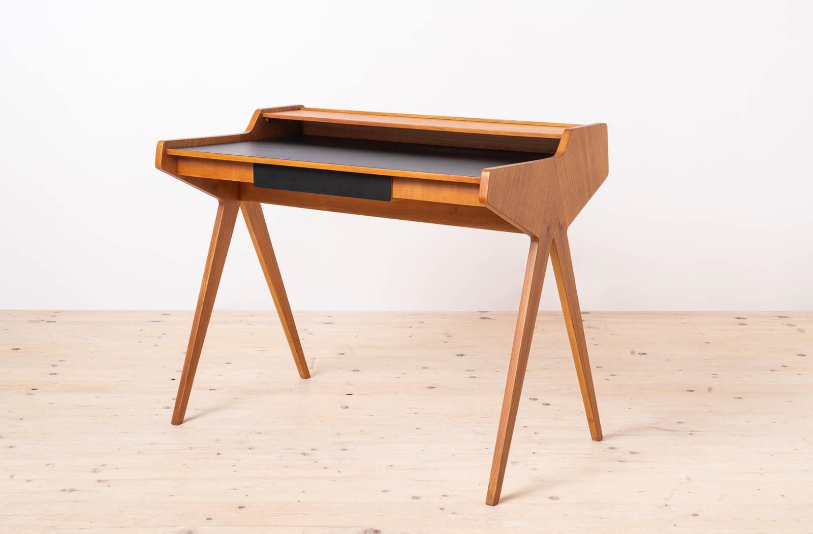 This is the famous desk designed by Helmut Magg, also known as „Lady Desk”. Produced in Germany by Neue Gemeinschaft für Wohnkultur, WK Möbel in 1950s. The design is simple yet very elegant. It features one practical drawer and a shelf above the