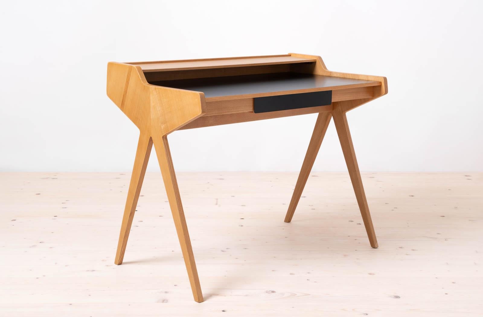 This is the famous desk designed by Helmut Magg, also known as „Lady Desk”. Produced by Neue Gemeinschaft für Wohnkultur, WK Möbel in 1950s. The design is simple yet very elegant. It features one practical drawer and a shelf above the top. The desk