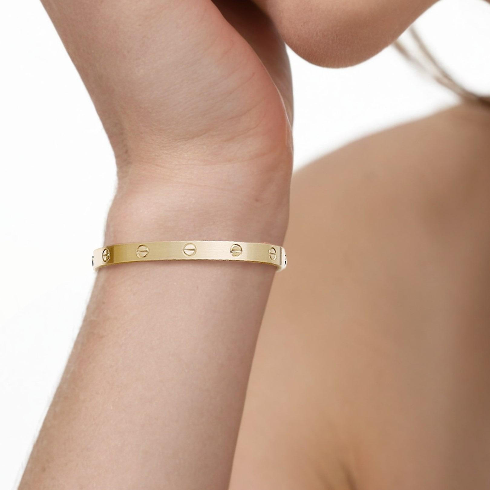 Timeless and sophisticated, this Iconic Luxury Bangle Bracelet is expertly crafted in solid 18K yellow gold, radiating a warm, rich glow. Its sleek, minimalist design embodies understated elegance, making it a versatile piece for both daily wear and