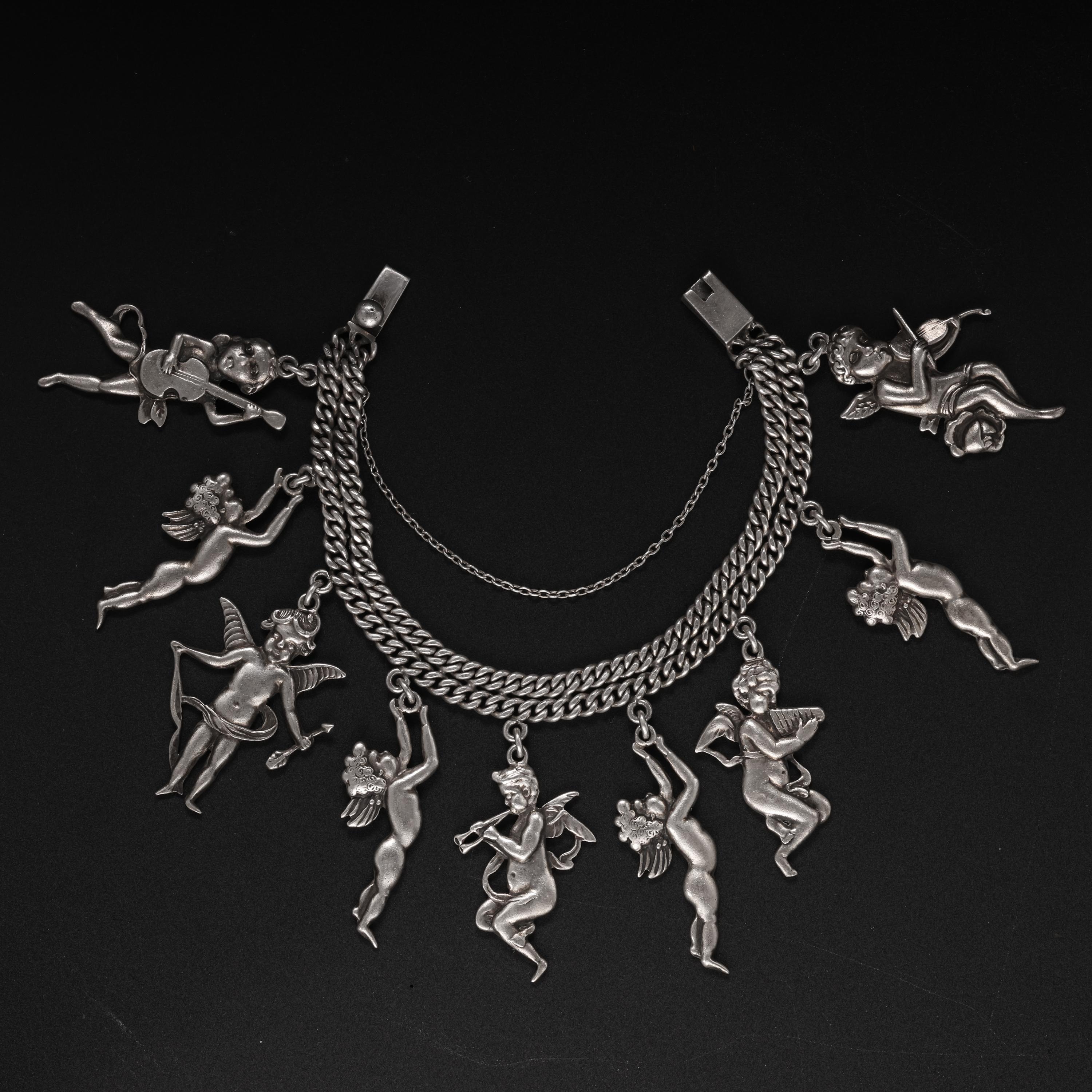This silver cherub charm bracelet by Margot de Taxco is featured in the book, 