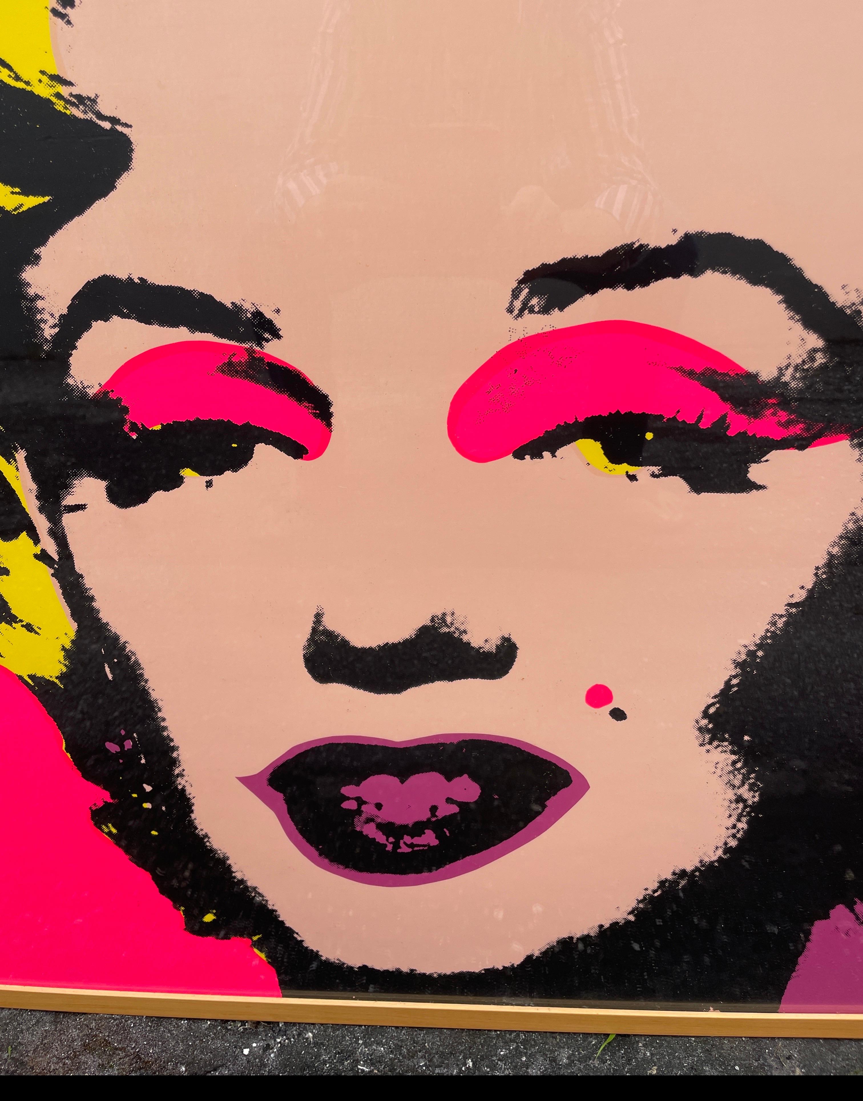Serigraph from the Iconic Marilyn series by Andy Warhol. A wonderful example with a vibrant hot pink background in a wood frame.