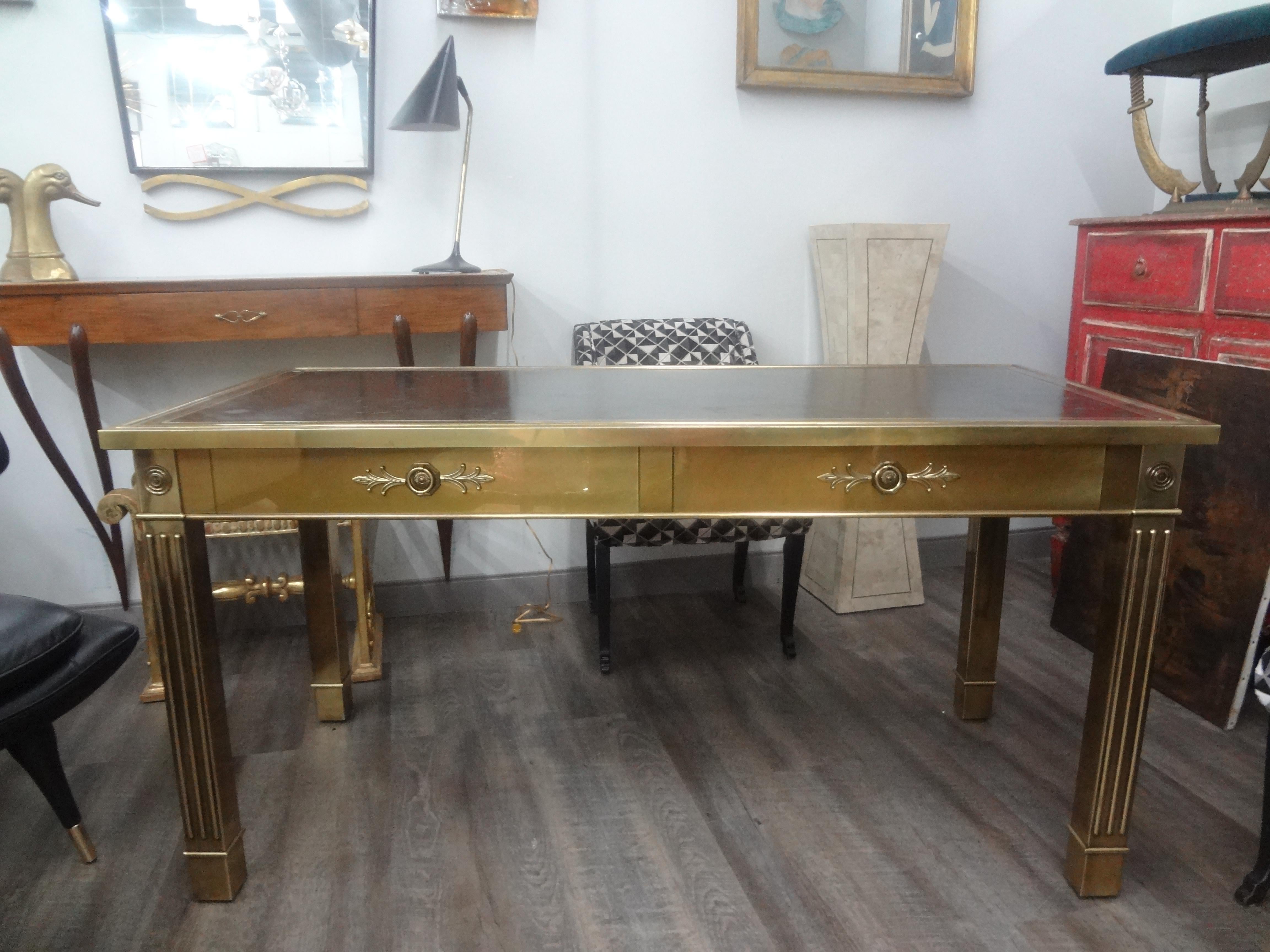 Iconic Mastercraft Brass Desk With Leather Top.
Stunning large mid century brass desk or writing table by Mastercraft.
This handsome desk has fluted legs with two drawers and a tooled black leather top.
Our classic Louis XVI style brass desk with